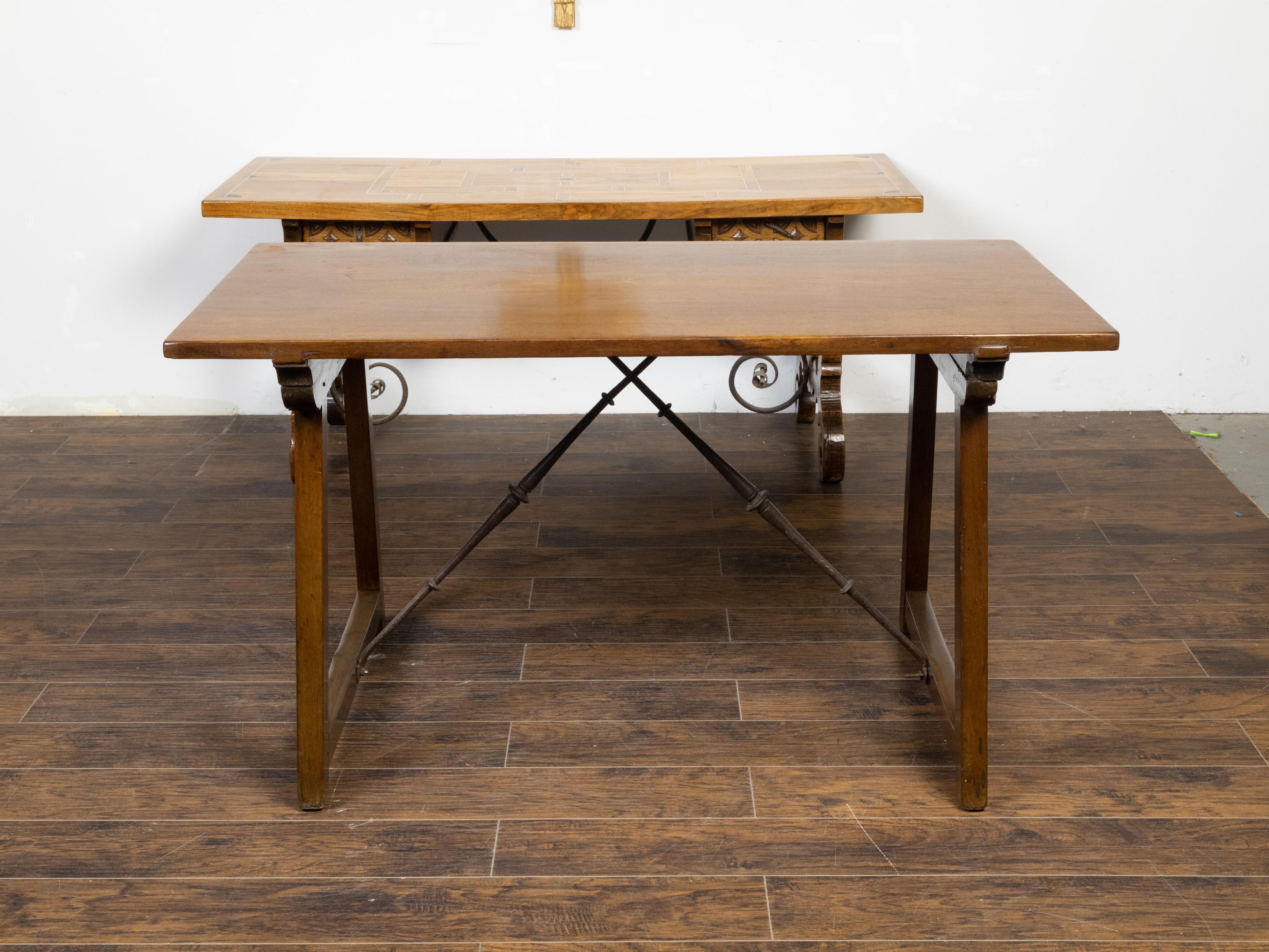 A French walnut console table from the 19th century, with trestle base and iron stretchers. Created in France during the 19th century, this walnut table features a rectangular top sitting above a trestle base made of splaying legs with low