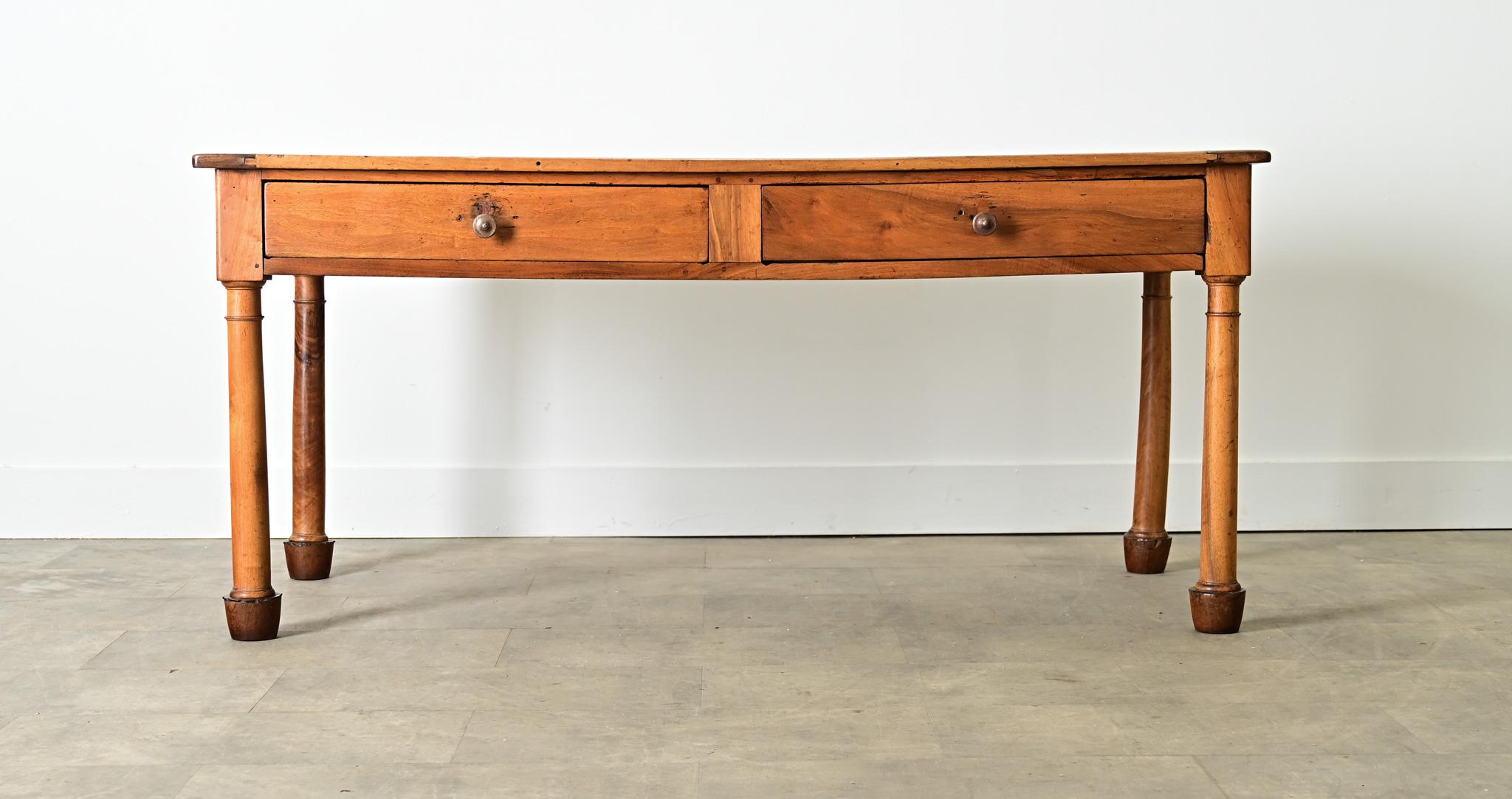 A strapping French 19th century solid walnut desk to anchor an office, library, or study with its reassuring presence and beautiful patina. The smooth top planks are arranged in a classic, “breadboard” formation, with a slight dip in the center from