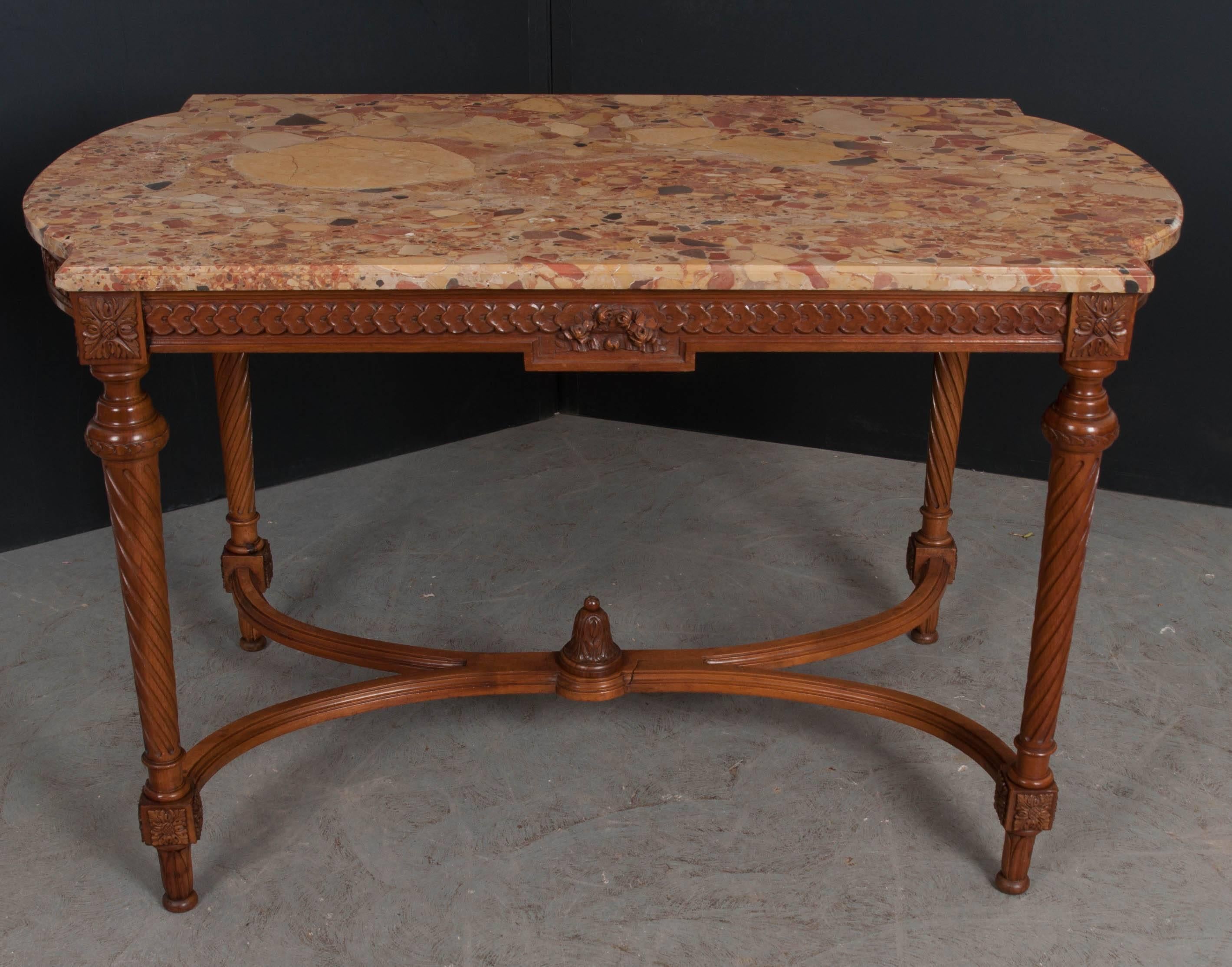 A gorgeous French 19th century Louis XVI style centre table, topped with a beautiful piece of Breche d’Alep marble. The shaped marble-top is shaped to fit the walnut base. The table’s apron has mirrored running coin carvings that extend from the