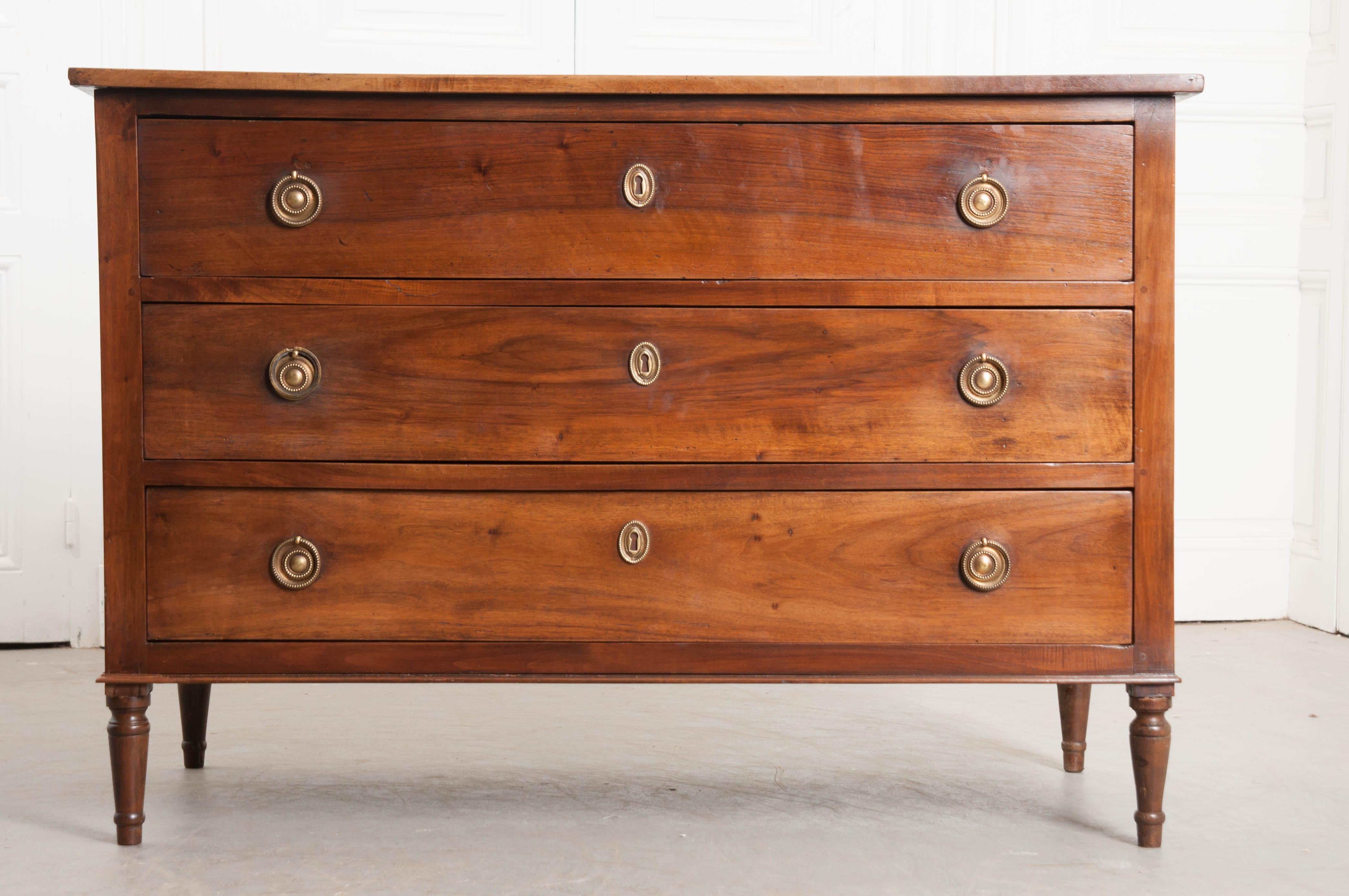 A fantastic solid walnut Louis XVI style commode from 19th century France. The commode’s simple styling allows the exceptionally beautiful walnut speak for itself. Three wide drawers can be found in the case piece, each equipped with oval beaded