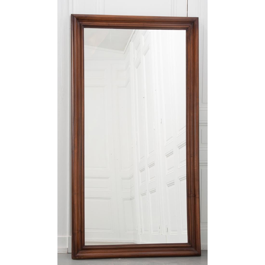 This handsome walnut mirror is from France and features its original mirror plate exhibiting crystallization. Uncomplicated yet substantial and attractive, this mirror is sure to add Provincial charm to any room you choose.