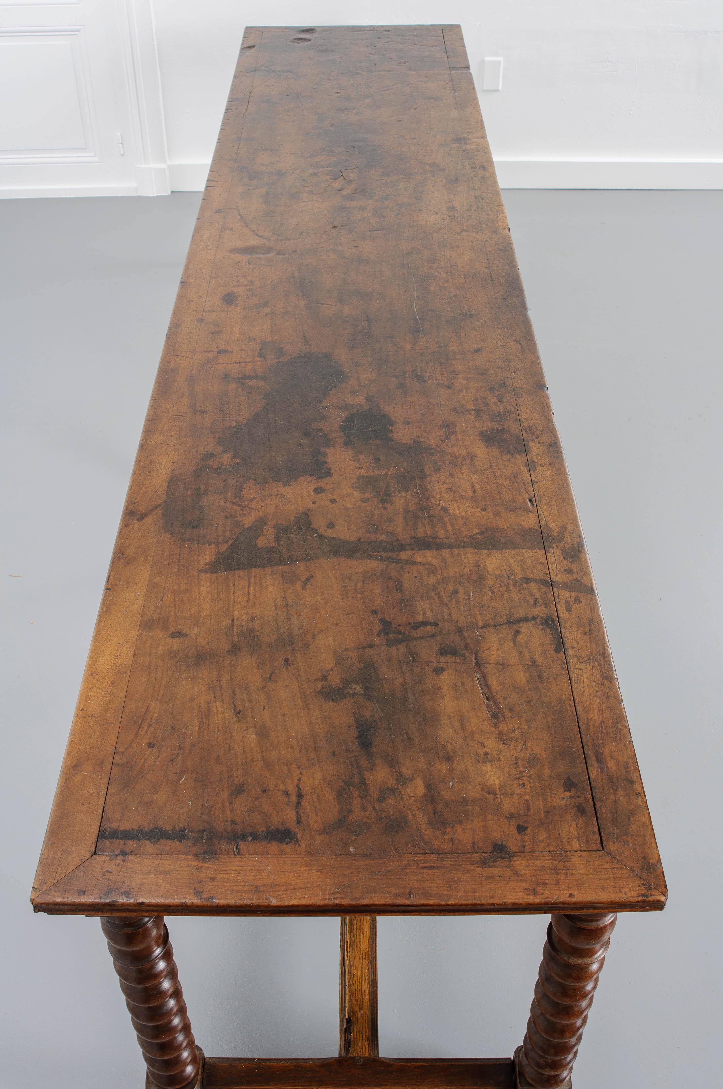 A unique dining table, indeed, this French 19th century walnut and oak farm table was originally purposed as a drapier’s table. Its long, narrow form lends itself to both tailoring window treatments as well as feeding a host of folks in a galley