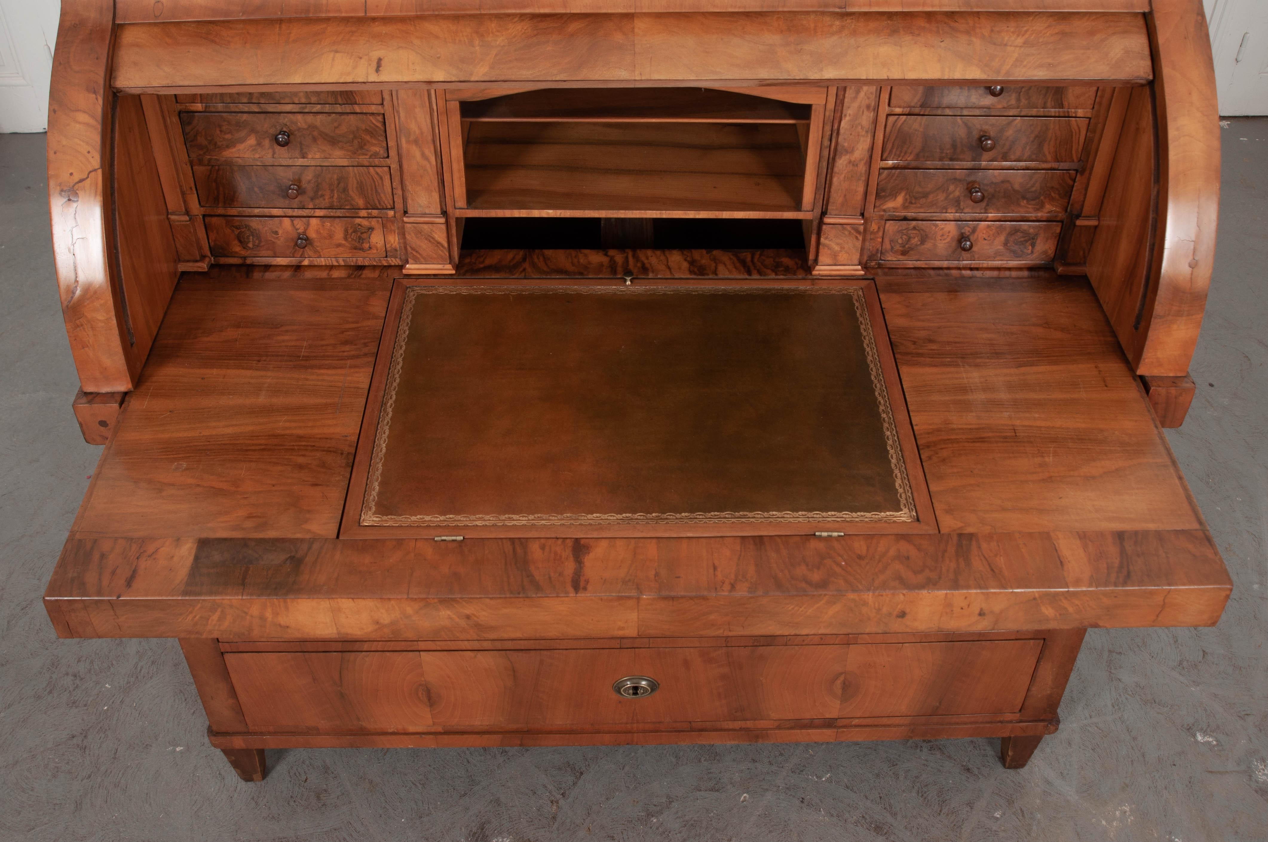 An impressive antique walnut desk, with roll top, from 19th century, France. This handsome desk showcases the ingenuity and creativity of many 19th century furniture makers. It has many mechanical features that are seldom seen in antiquity. Using