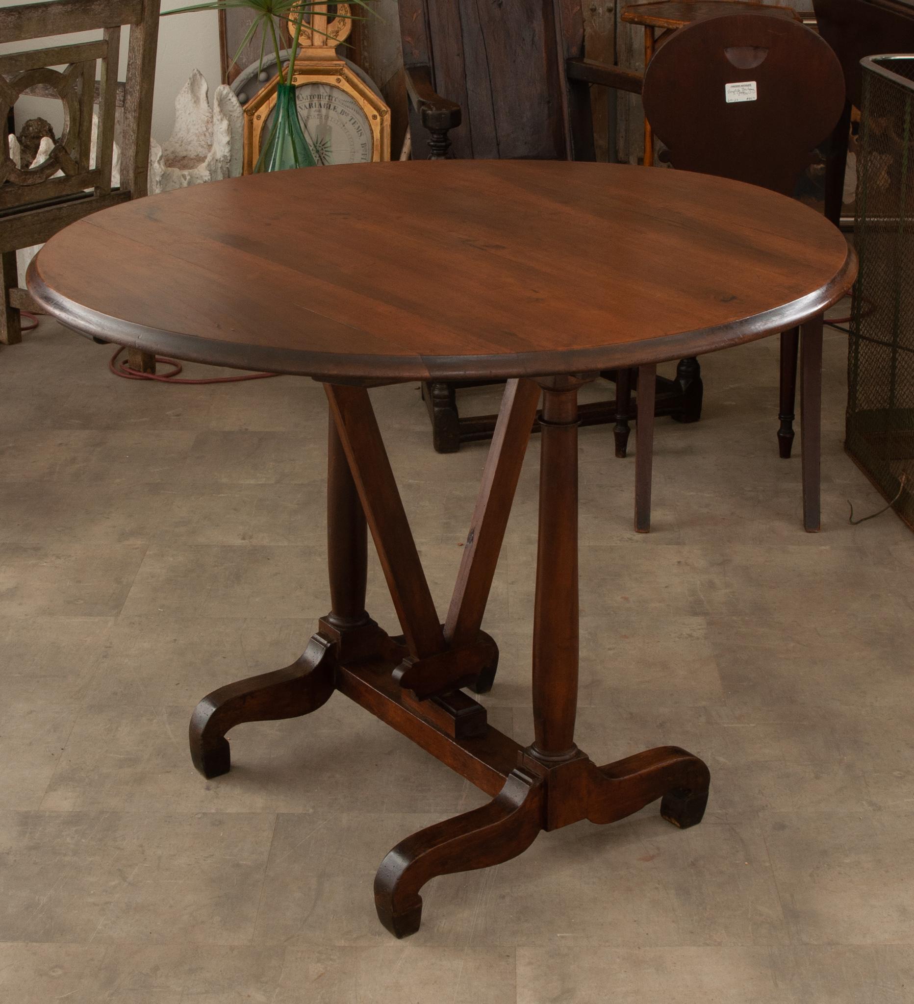 A 19th century French vintner’s wine tasting table. A specialized folding tilt-top table that was used at vineyards and wineries across Europe, providing a place to taste their different vintages. Vendange (grape harvest) tables have a tilting