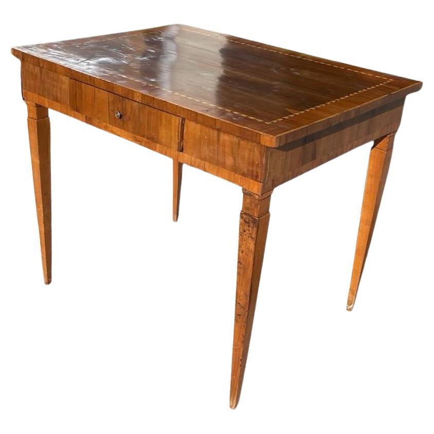 This is a fine example of a French 19th Century end table. It is made of walnut veneer with rosewood inlay on the top. There is one front small drawer. It would be ideal as a small desk. 