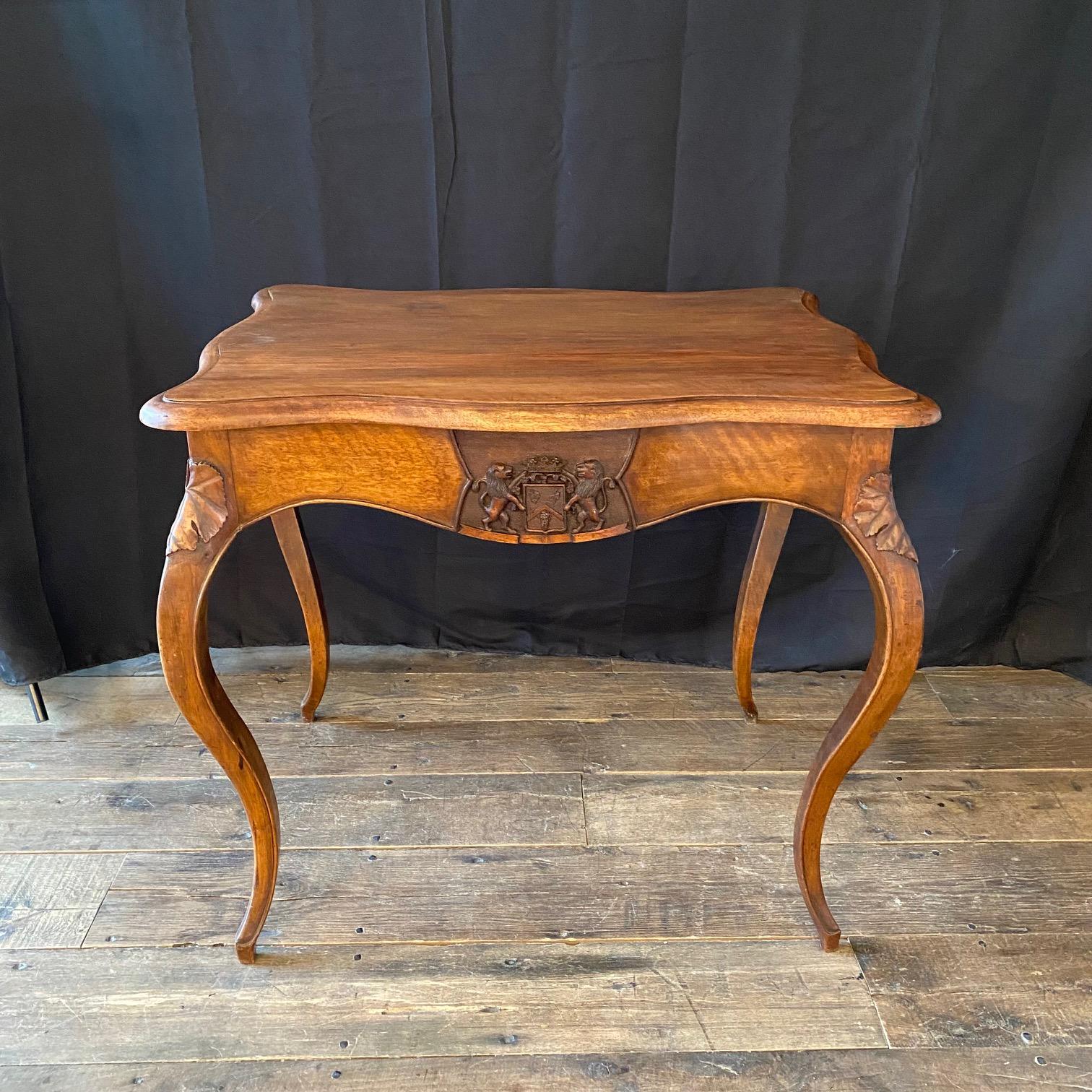 Antique French accent table or side table that would make a stunning writing table or desk as well, sure to add elegance and museum quality interest in any room in the home! Direct from France,  the original large crest in shield sets the tone and