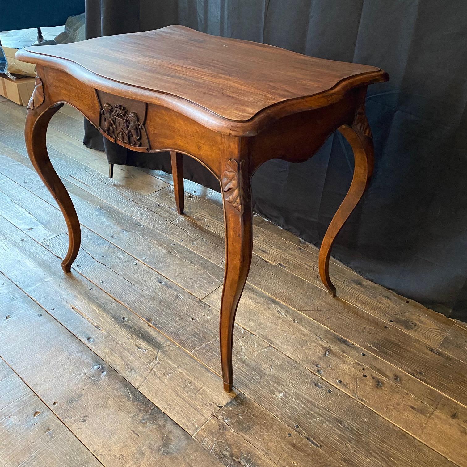 French Provincial French 19th Century Walnut Writing Table or Desk with Lions and Shield Crest For Sale
