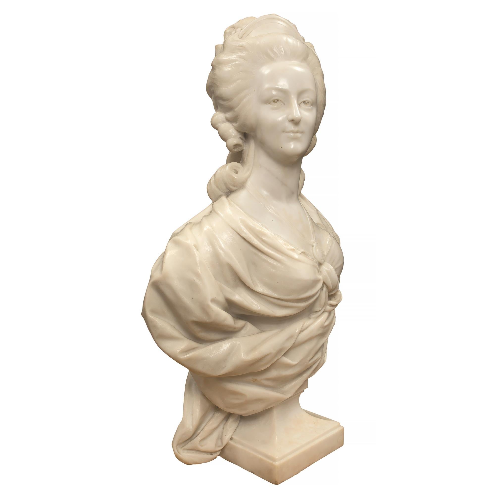 A beautiful French 19th century white Carrara marble bust of Marie Antoinette. The high quality bust is raised by a square base. The richly detailed marble bust of Marie Antoinette displays her in a most elegant attire with a pendant medallion of