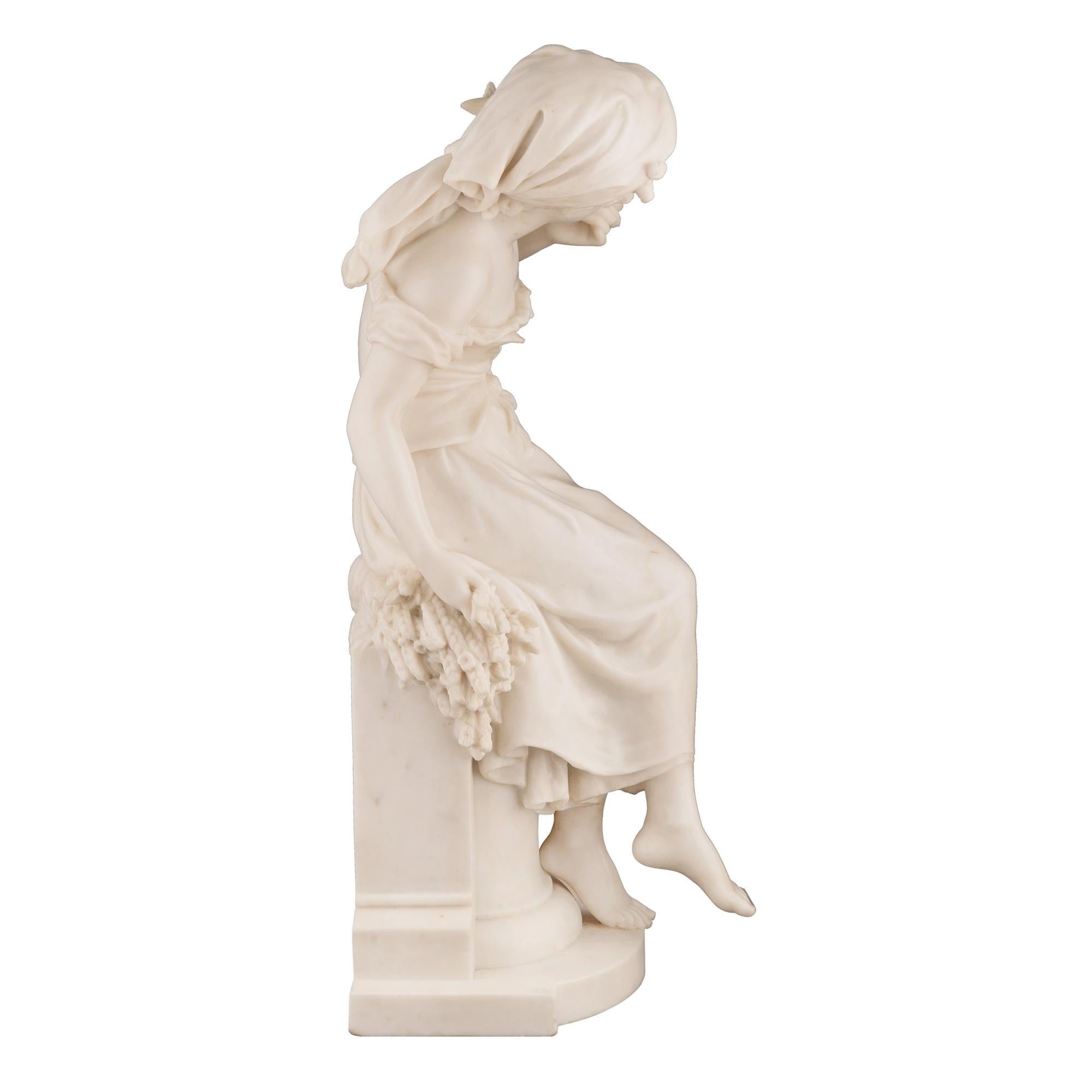 A stunning French 19th century white Carrara marble statue of a beautiful young maiden, signed Math Moreau. The statue is raised by a demi lune shaped tier with an elegant pedestal displaying a mottled border with a sickle and tied wheat sprigs at