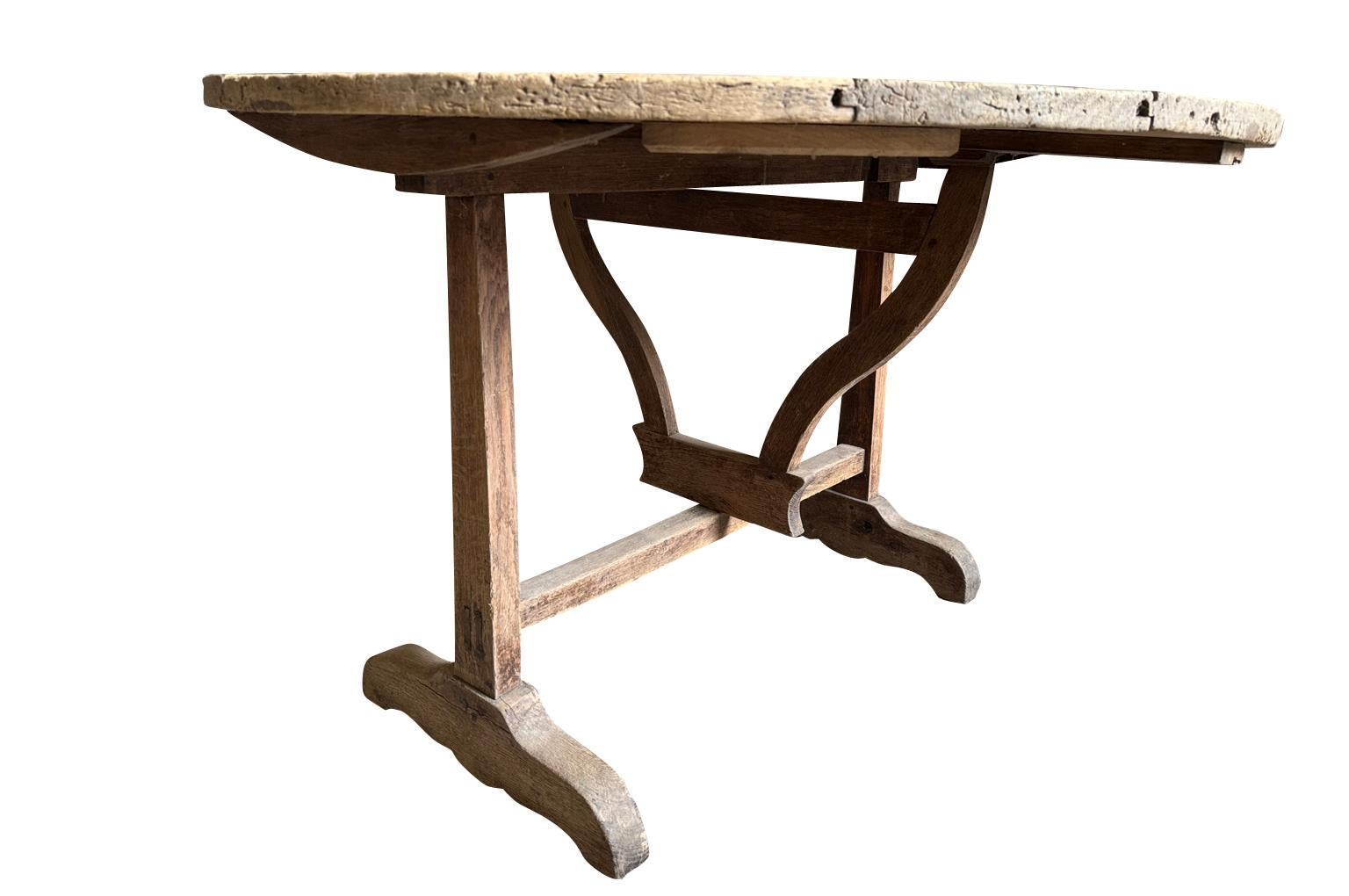A very charming later 19th century Table Vigneron - Wine Tasting Table from the Provence region of France.  Wonderfully constructed from sound poplar with a tilting top and a parquet top surface.  Super patina.