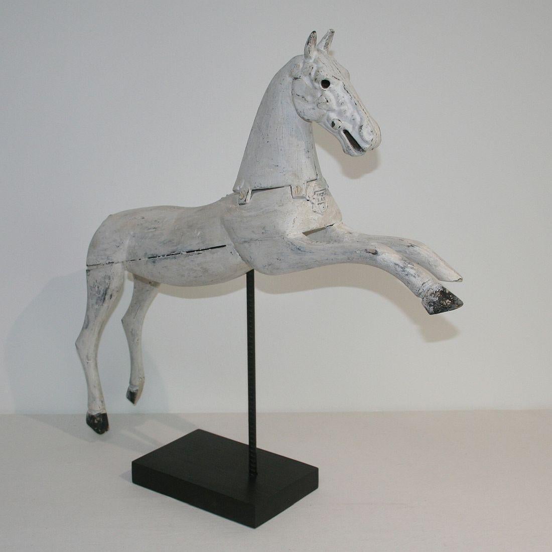 Beautiful white wooden horse with cast iron head, France, 19th century. Weathered, small losses. Measurement with the base.