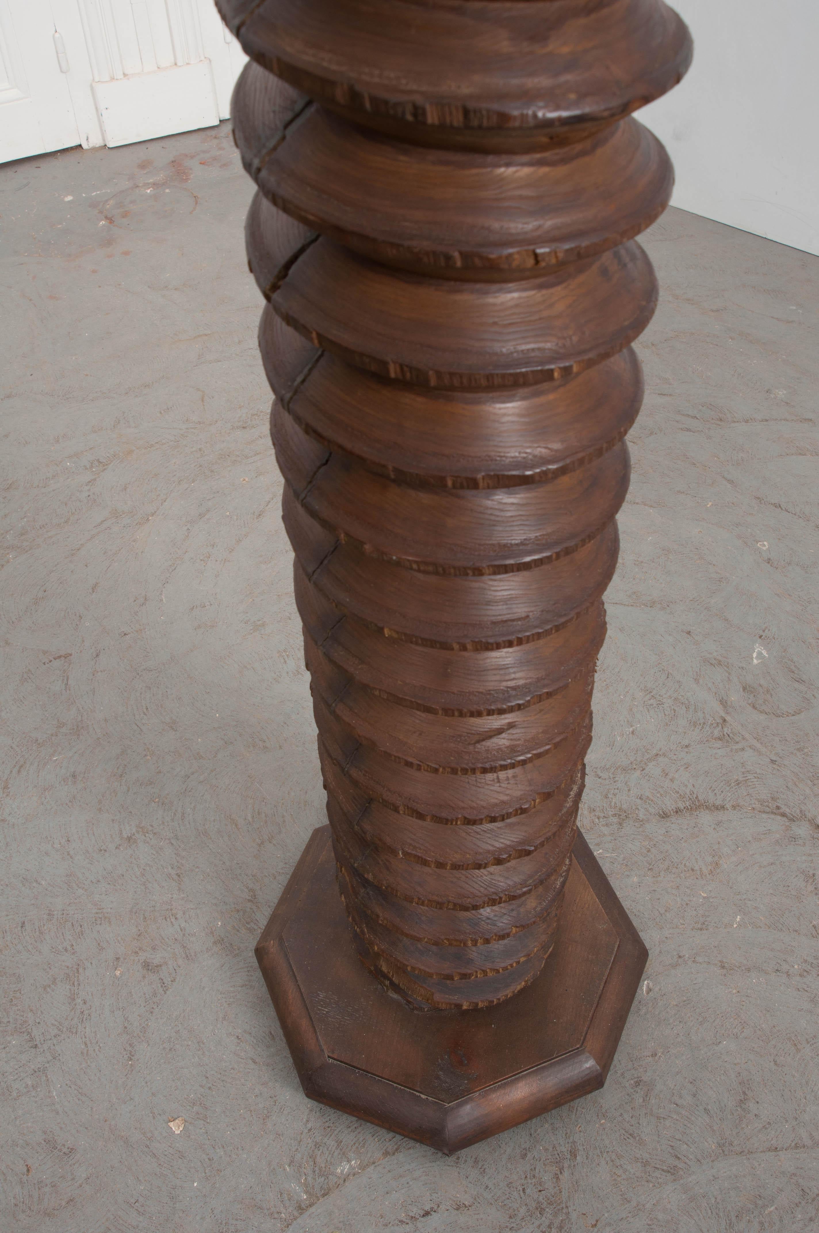 This wonderfully-aged 19th century wine press screw, from a vineyard in France, has been converted into a pedestal with a later octagonal top and base. This antique press screw, with a deep, rich staining and patina from the grapes could also be