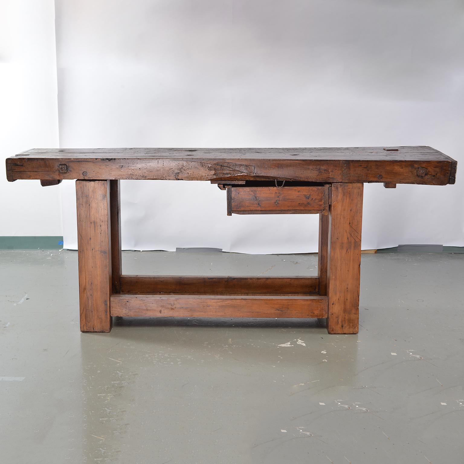 French wooden work bench table, circa 1860s. Long, narrow and very sturdy, this makes a great console or bar table. Bench has two drawers one slightly off-center with dividers, the other a very small drawer at the end (for nails or screws). Lower