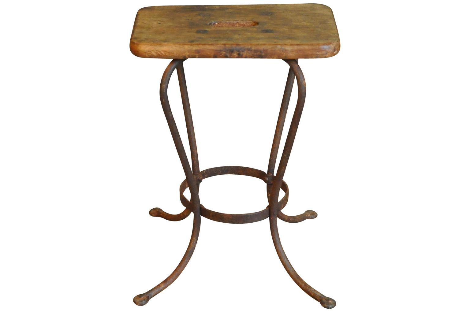 A delightful work stool from the South of France. Soundly constructed from wood and iron with an ergonomic seat.