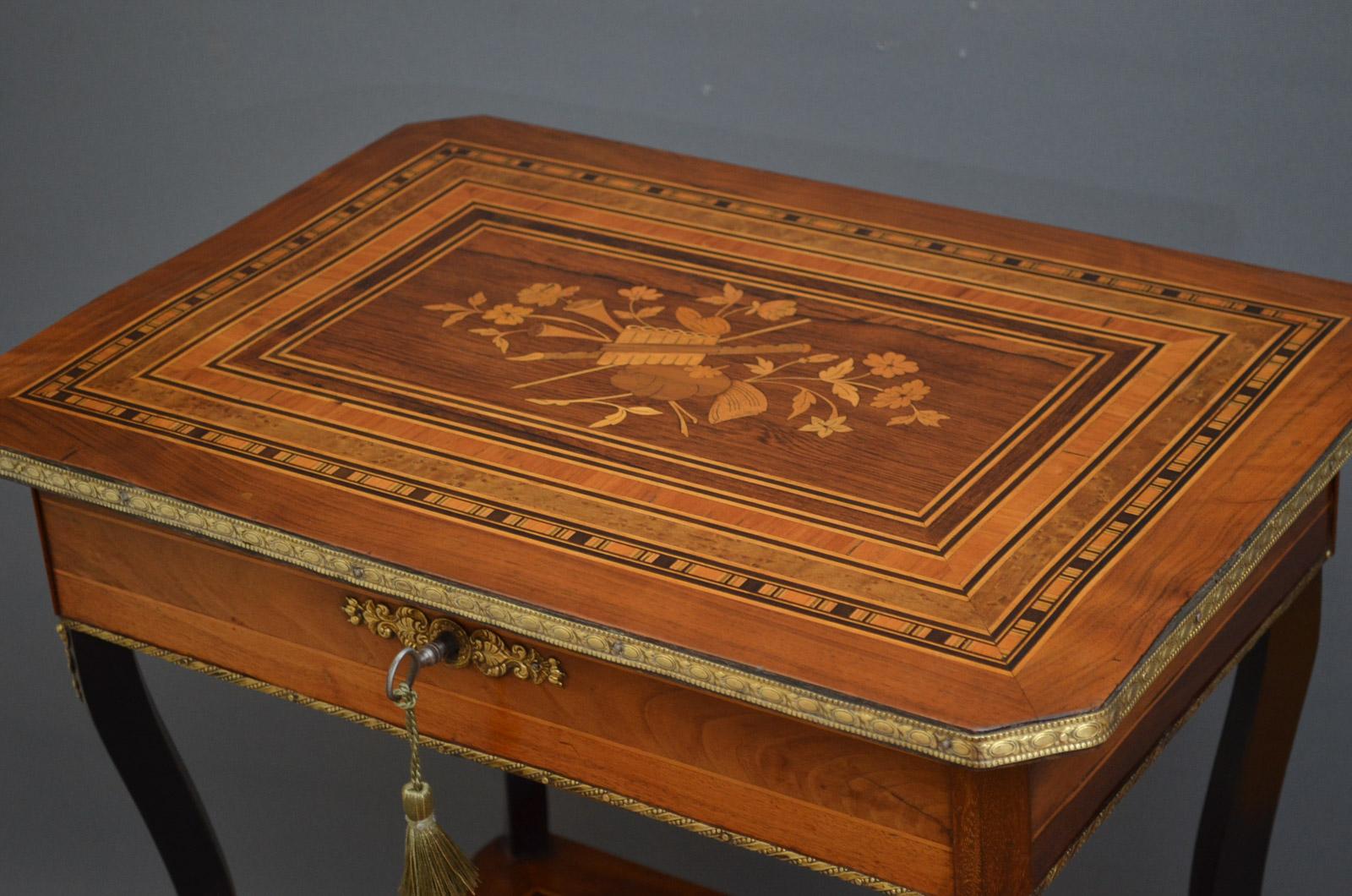 Sn3184, stunning, Continental sewing table, having multi wood top inlaid with rosewood, walnut, bird's eye maple, satinwood, kingwood and ebony with brass edge enclosing compartments and needle cushion, inlaid frieze and shaped ebonized legs united
