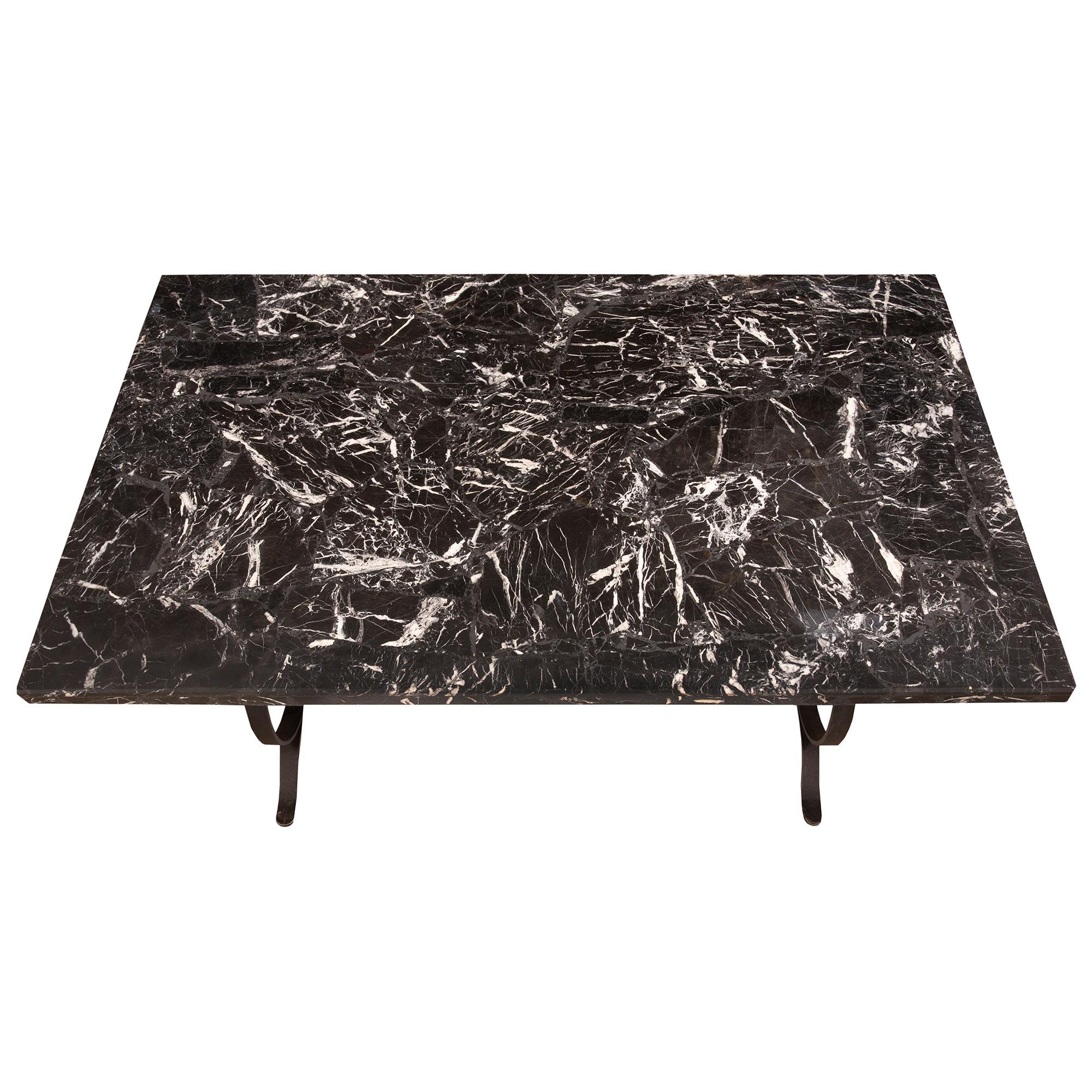 A most decorative Country French 19th century wrought iron and grand antique marble center or dining table. The table is raised by an elegant wrought iron base with beautiful scrolled designs joined by a stretcher. Above is the original grand