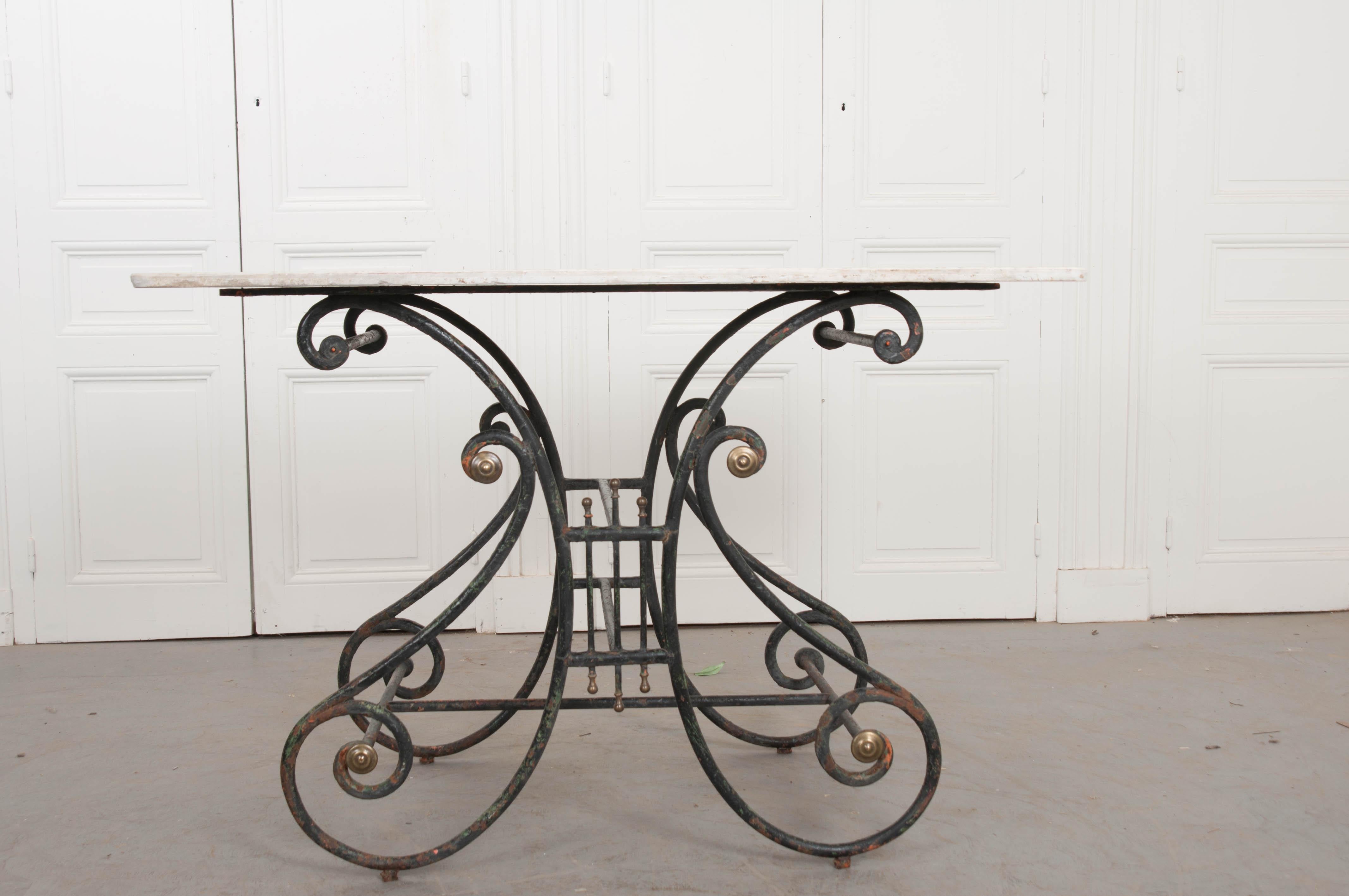 This beautiful French pastry table, circa 1880s, has a well-proportioned wrought-iron lyriform base with brass accents and the original white marble top. It can be used in almost any room in the house, but would be most helpful as a kitchen island,