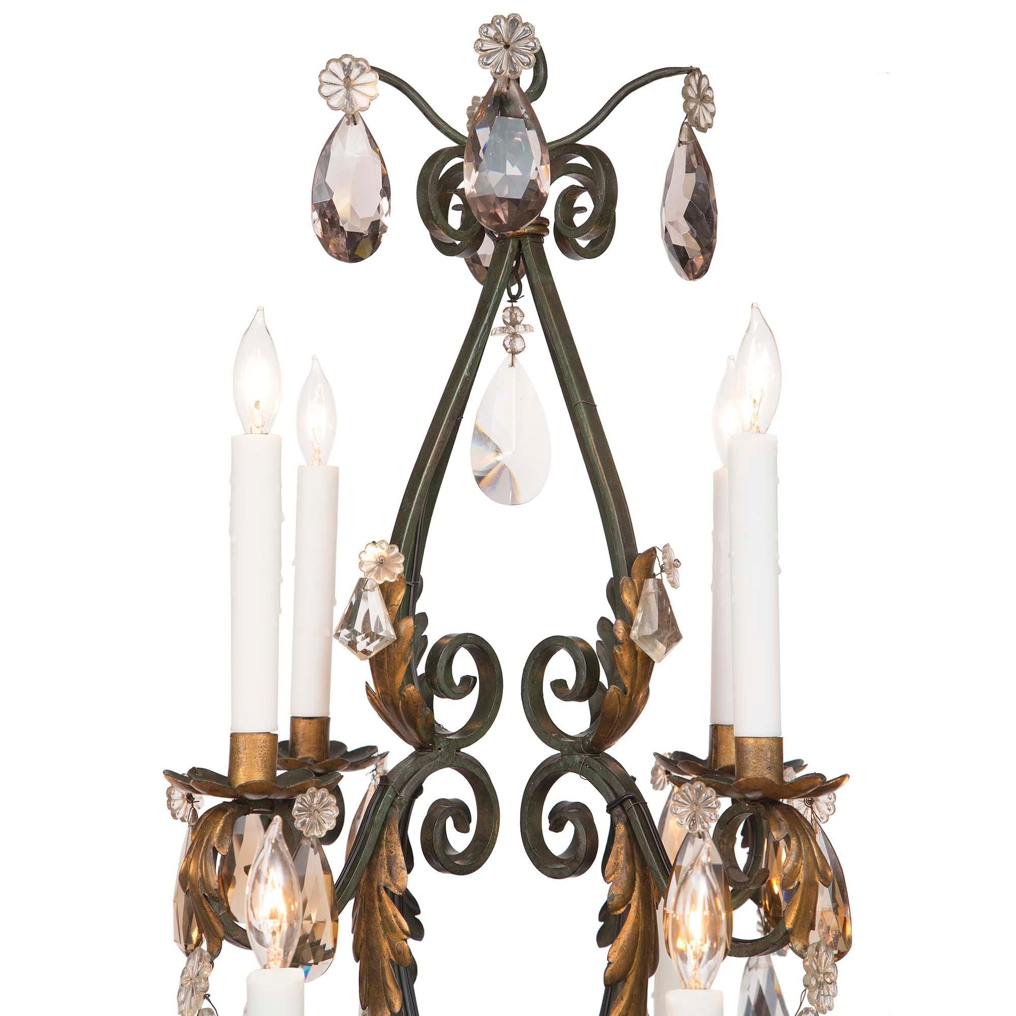 A country French 19th century wrought iron, gilt metal and Baccarat crystal chandelier. At the center bottom is a wonderful crystal cluster of amethyst crystals designed to look like a grape cluster. The chandelier with a wonderful scrolled open