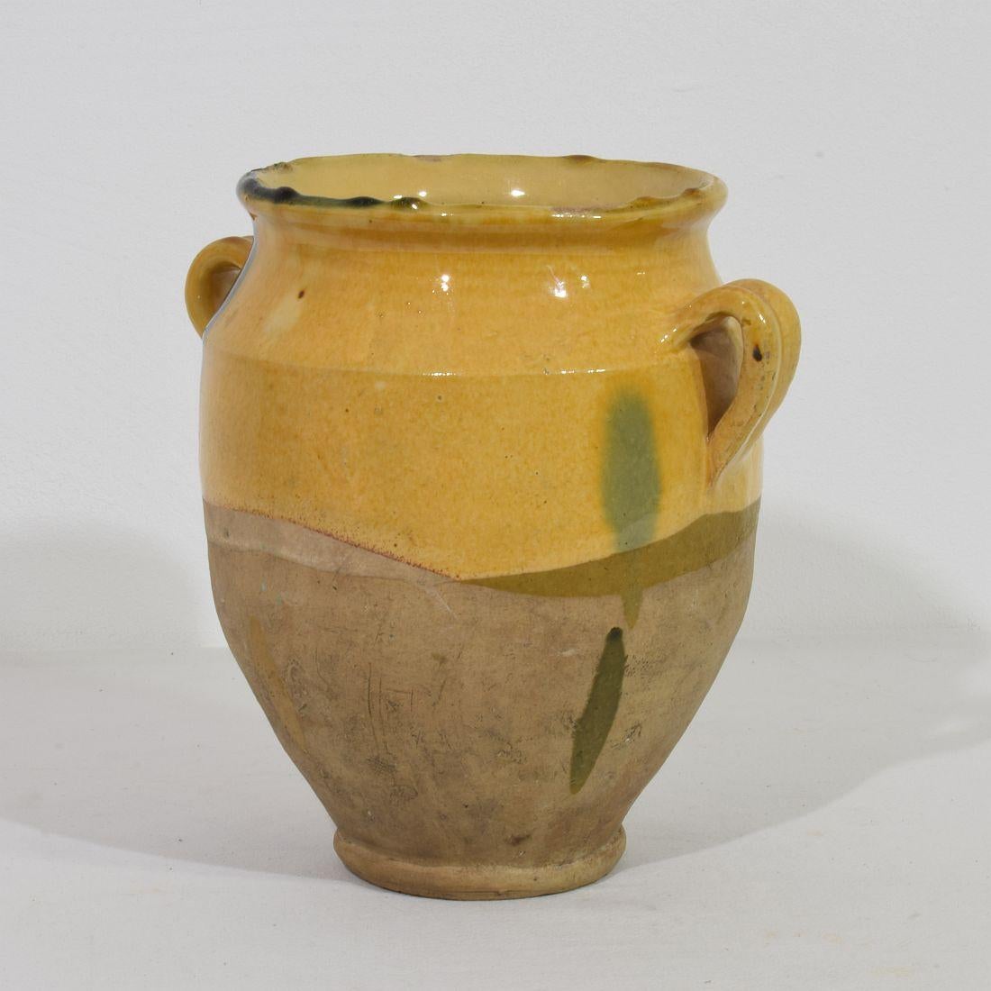 Beautiful confit jar with its characteristic yellow glaze. What makes this item so unique is the beautiful green/blue stripe.
Confit jars were used primarily in the South of France for the preservation of meats such as duck or goose for dishes such