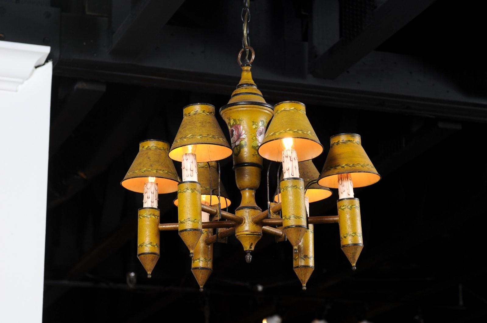 A French yellow tôle six-light chandelier from the 19th century, with hand painted floral décor. Born in France during the 19th century, this chandelier features a yellow-painted tôle structure, accented with black details and delicate floral