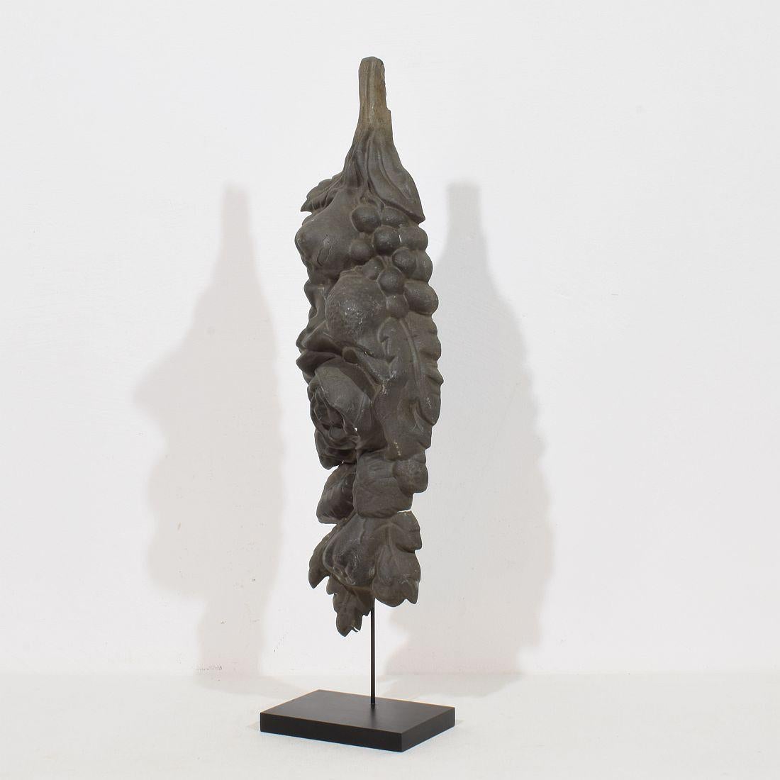 Lovely French 19th century zinc architectural ornament, depicting baroque fruit. This item once adorned a french facade and is now placed on a wooden base.
France circa 1850-1900.
beautiful weathered and patine. Old repair
H:59,5cm  W:14cm D:10cm 