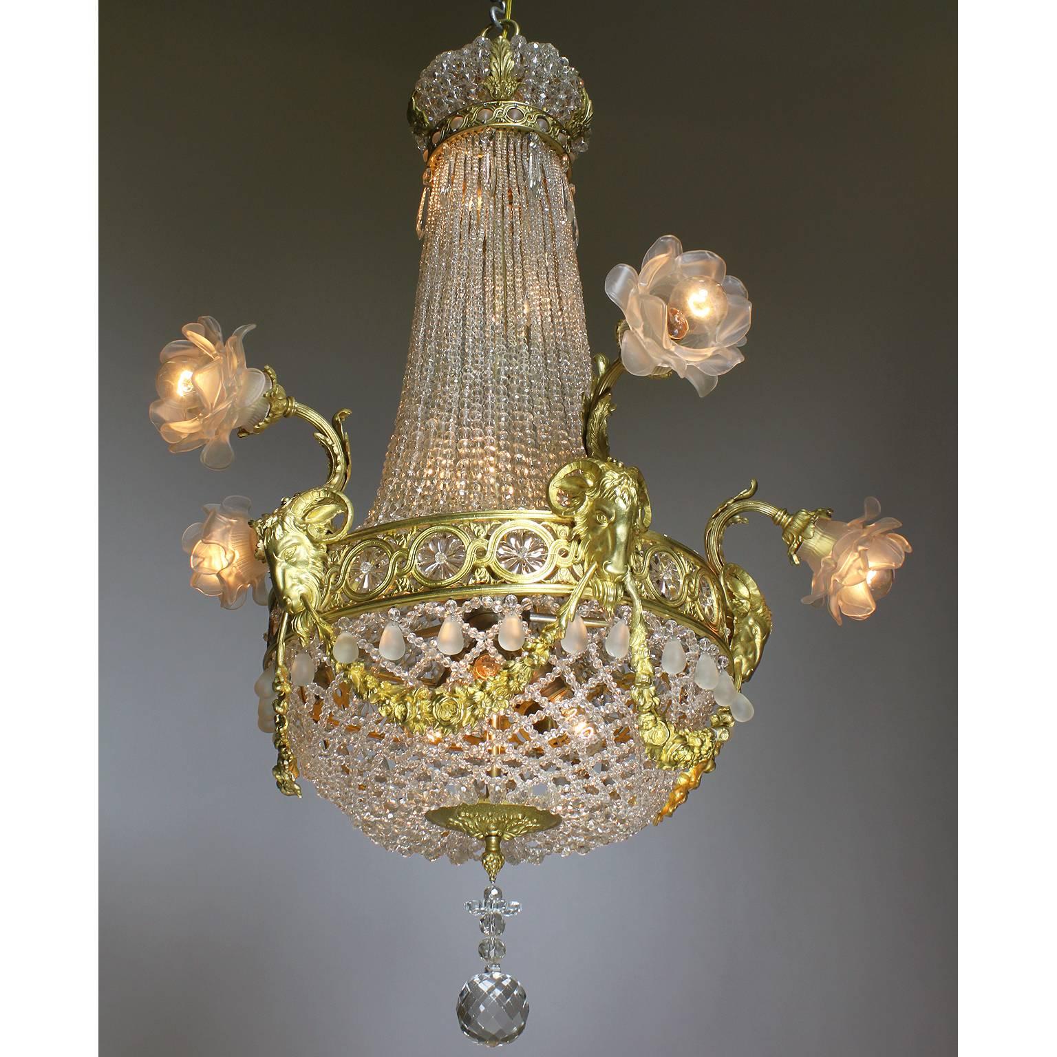 A fine French 19th-20th century Louis XVI style gilt-bronze and beaded glass twelve-light figural chandelier. The ornate gilt-bronze frame surmounted with six scrolled outer lights fitted with floral frosted glass shades, each above gilt-bronze