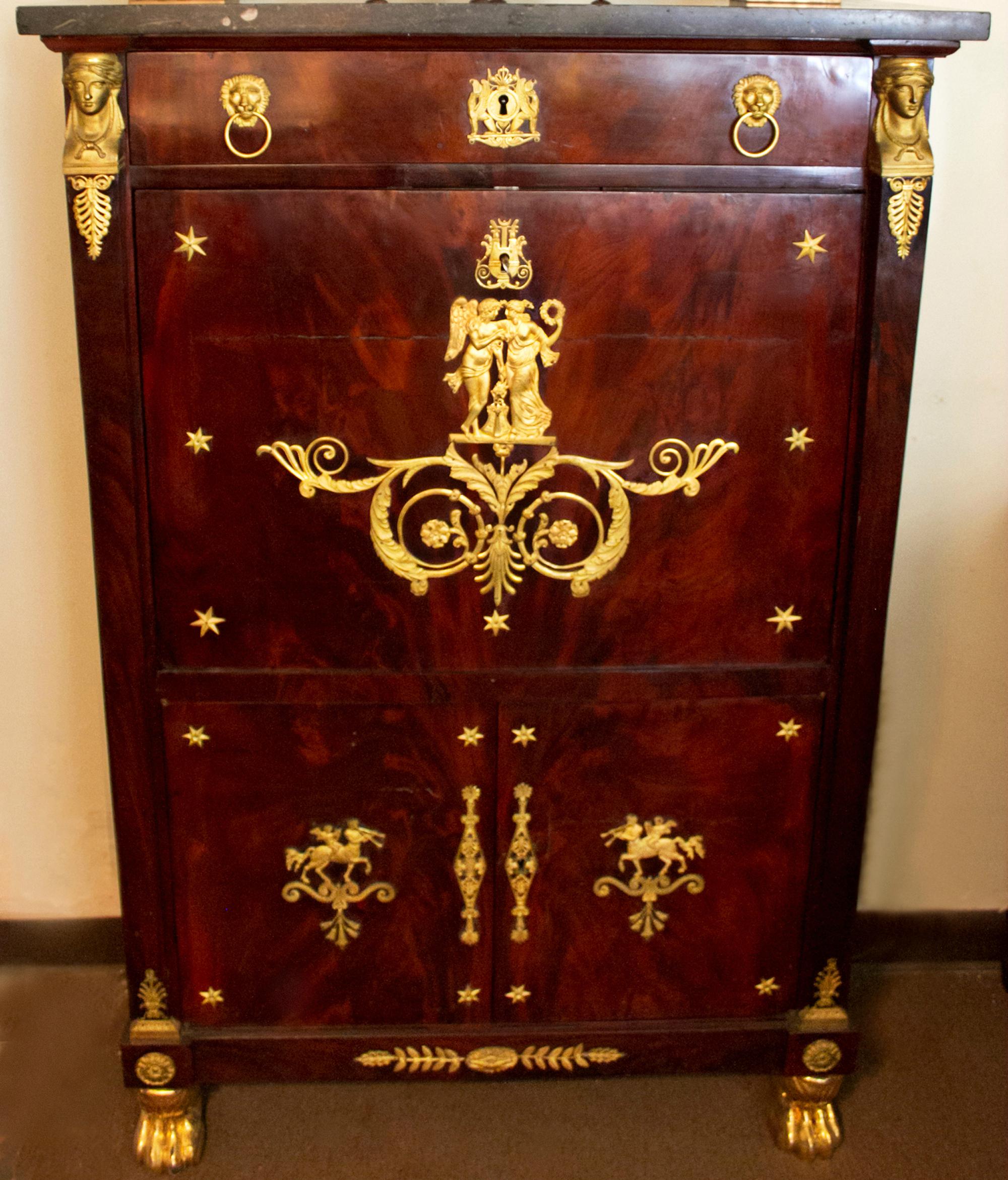 This extraordinary French Second Empire period secre´taire a' abattan features flame mahogany, gilt brass-mounts and retains its original dark grey speckled granite top. Decorated throughout with the original ormolu neoclassical motif, the facade is