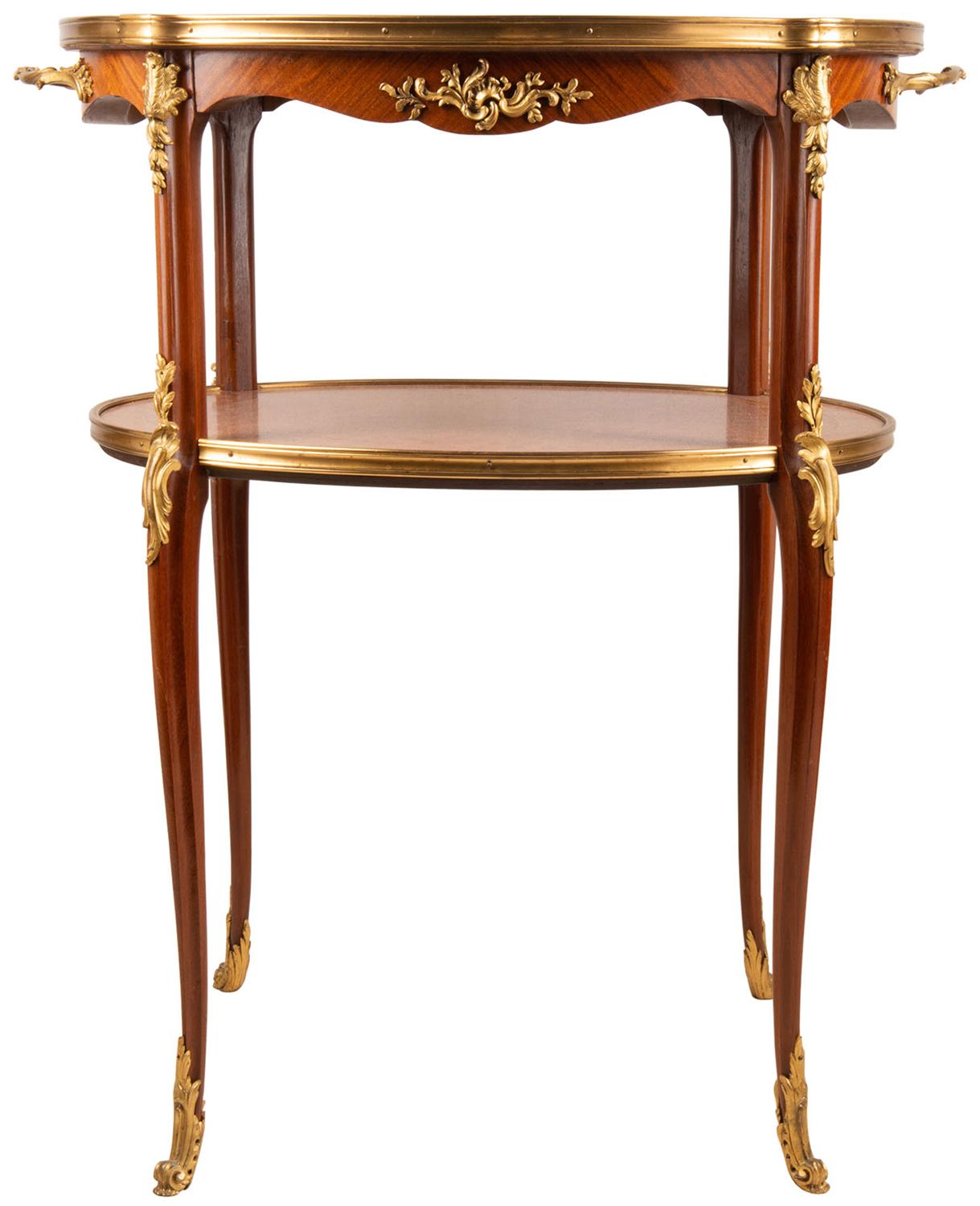 A fine quality late 19th century French two-tier étagère, having parquetry inlaid decoration, scrolling foliate gilded ormolu mounts, raised on elegant cabriole legs.
In the manner of Francoise Linke.