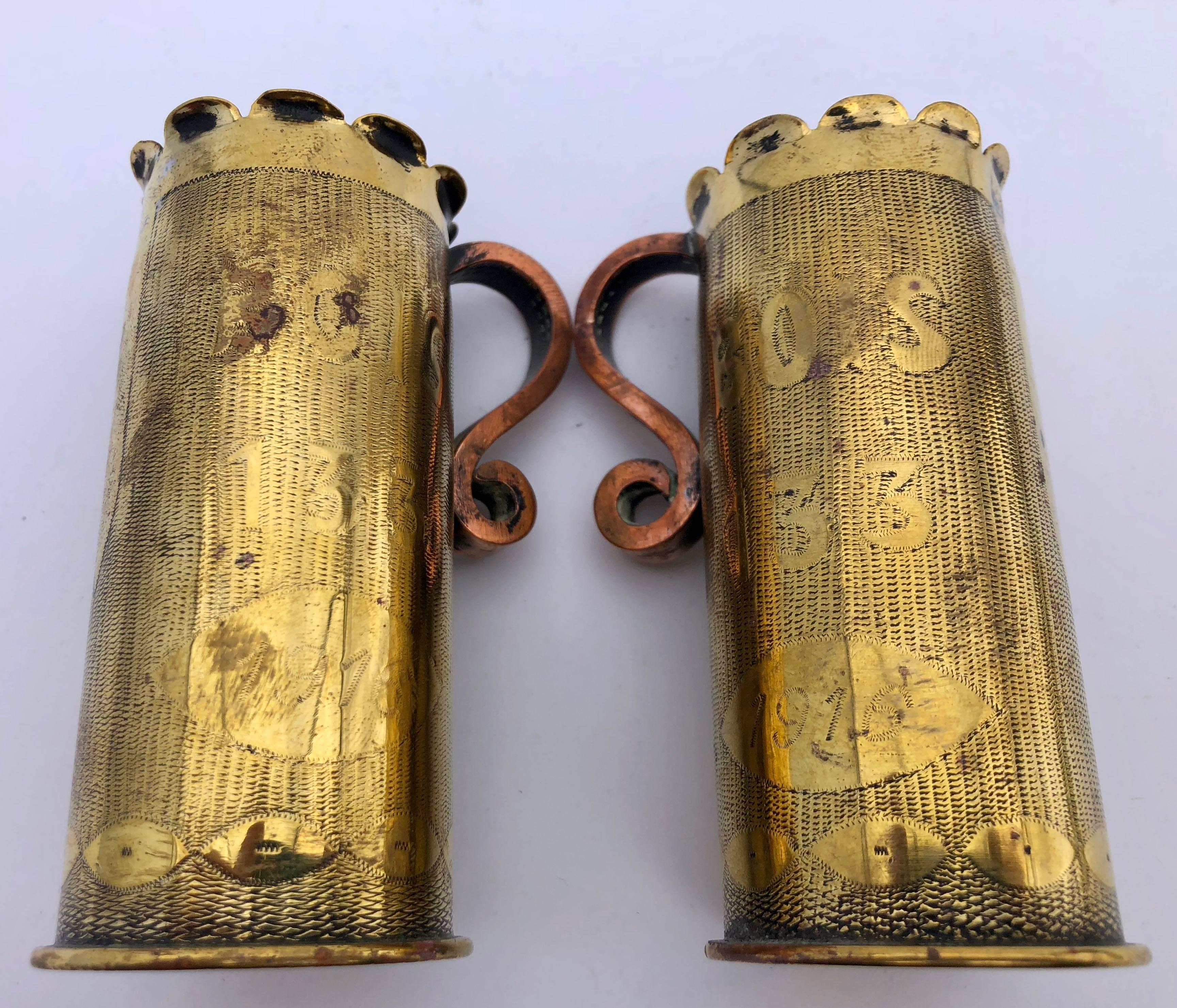 These are two beautiful French First World War brass shell case mugs with scrolled copper handles and scalloped tops. They are inscribed 