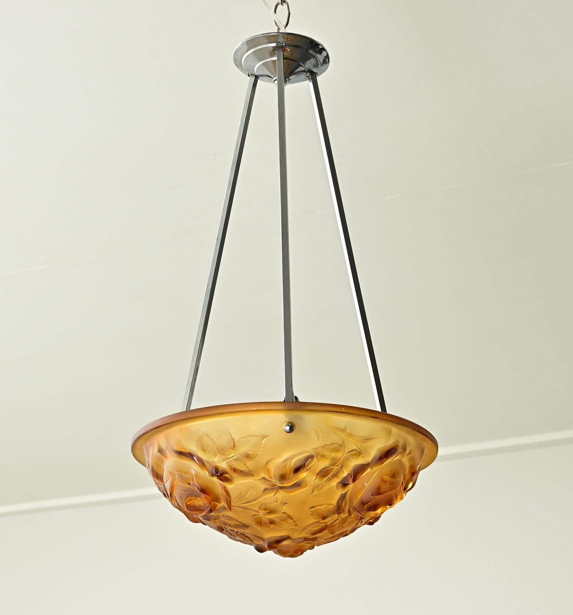 This French Art Deco pendant has an amber colored frosted glass with floral and foliate designs throughout. Recently wired for US electrical using UL listed parts and is ready to be hung in your interior. Be sure to view the detailed images to see
