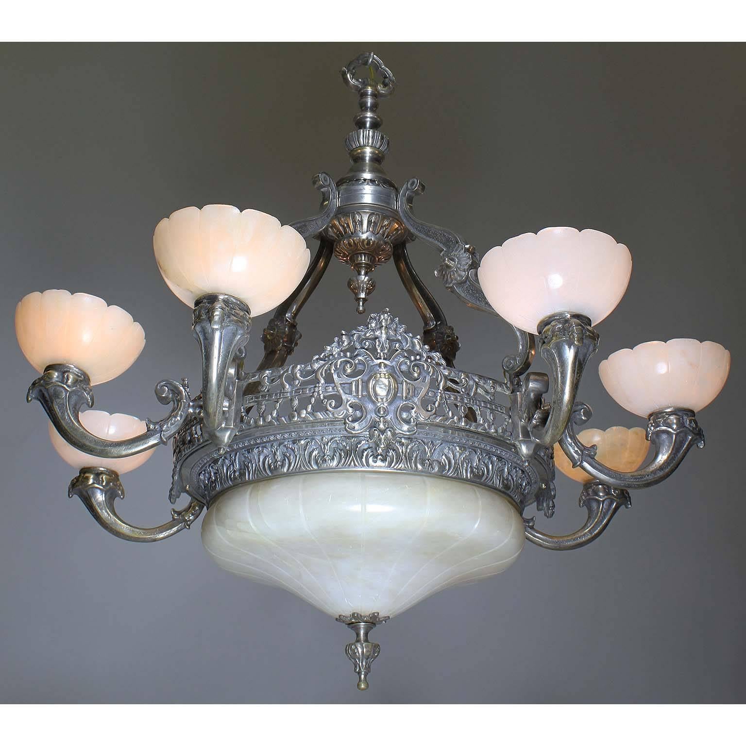 A French early 20th century Art Deco silvered bronze and carved alabaster eight-light chandelier. The pierced silver plated bronze frame, suspended by four 