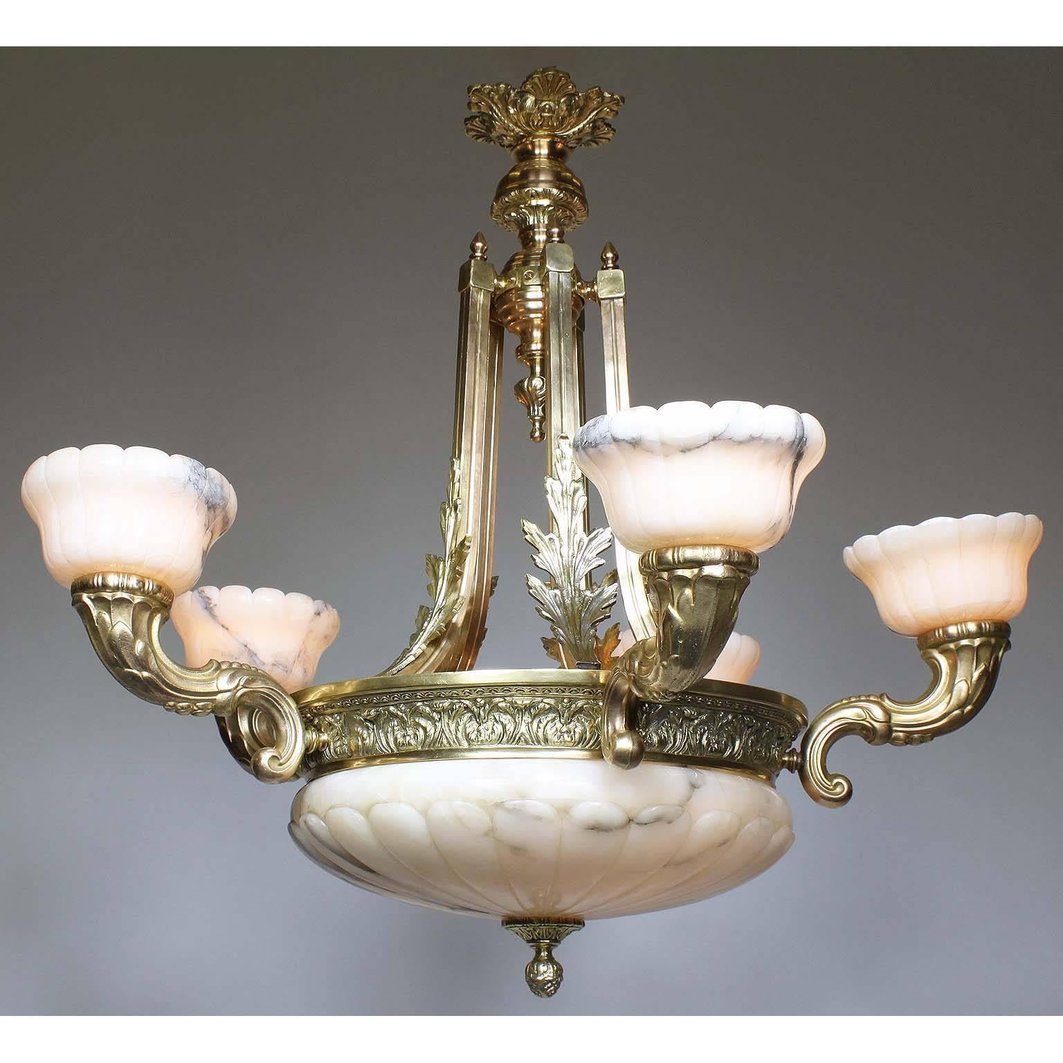 A French 20th century Art Deco style bronze and carved Veined Alabaster five-light chandelier. The carved circular alabaster plafonnier, with two interior lights and a finial drop, surmounted by five scrolled cornucopia shaped lights, all fitted