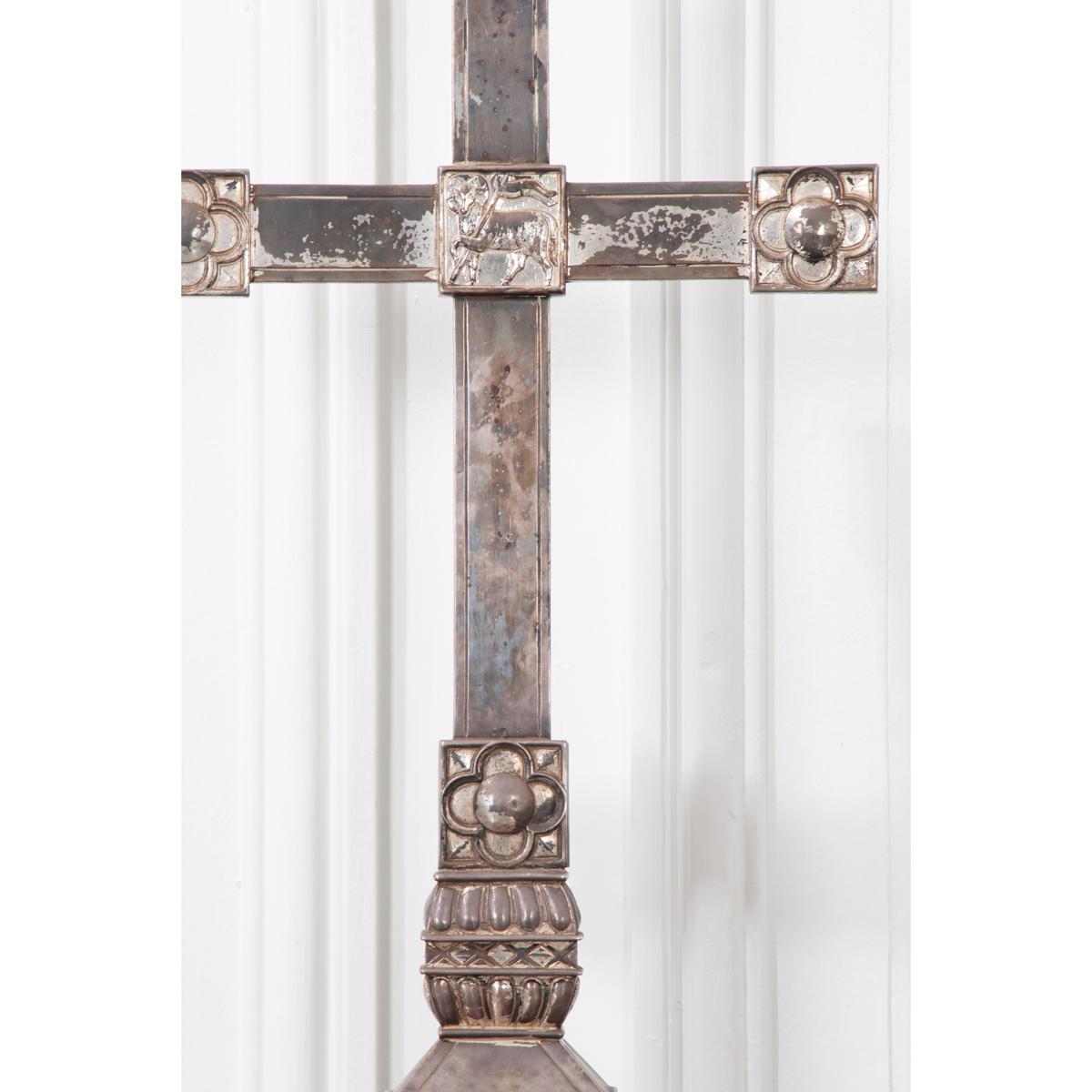 This is a lovely, vintage cross on stand. It is a beautifully patinated piece with a quatrefoil at each end and the ‘Lamb of God – Agnus Dei’ at the center. There is a memorial inscription across the front edge of the base, dated 1927.