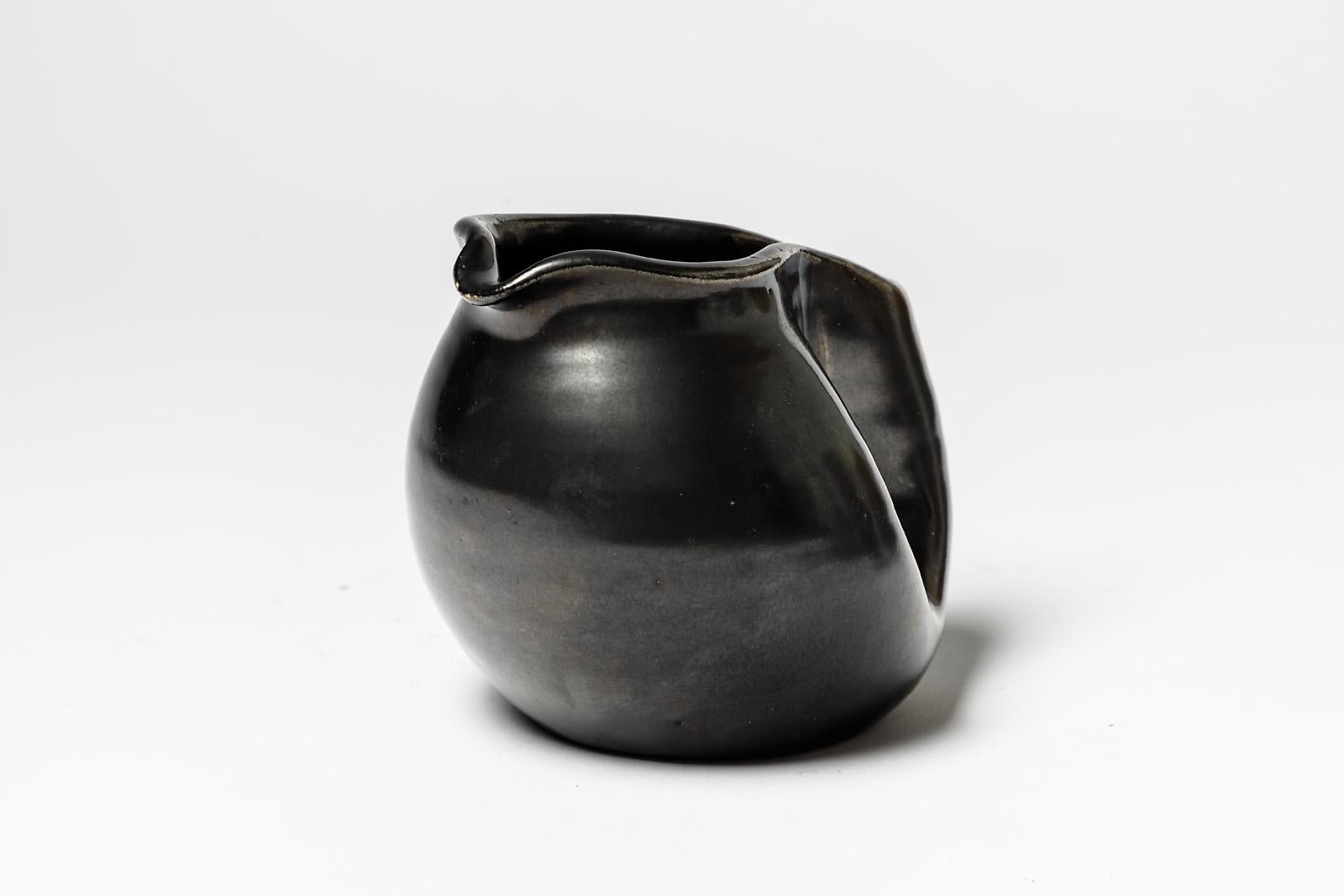 Pitcher

Black original and decorative ceramic pitcher

Realised circa 1950

20th century handmade ceramic production

Original perfect condition

Measures: Height : 11 cm, large : 13 cm, depth : 10 cm.