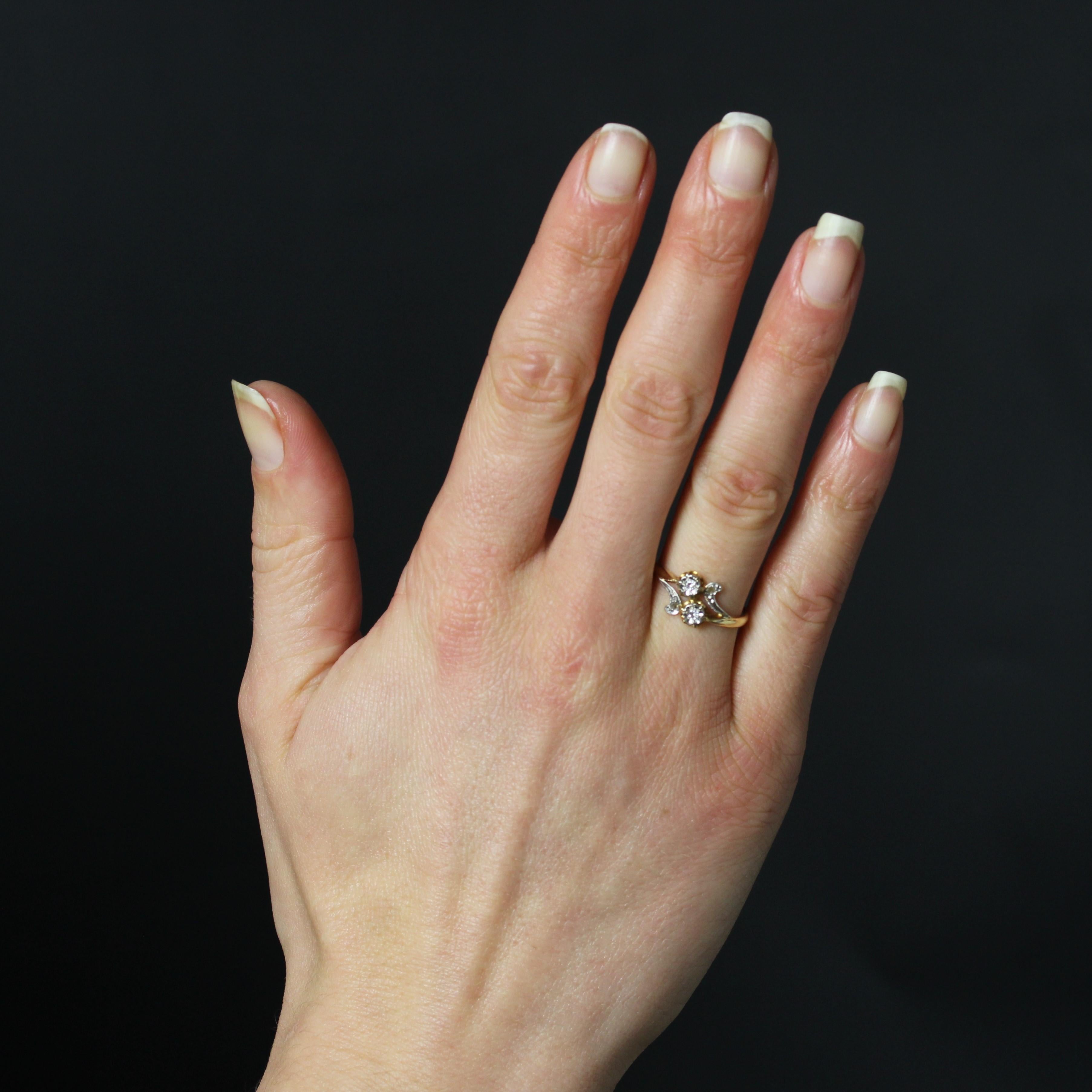 Ring in 18 karat yellow gold, horse head hallmark.
A delightful antique ring with a star-setting of two brilliant-cut diamonds on top, flanked on either side by two slender motifs, each set with a rose-cut diamond.
Total weight of the 2 main