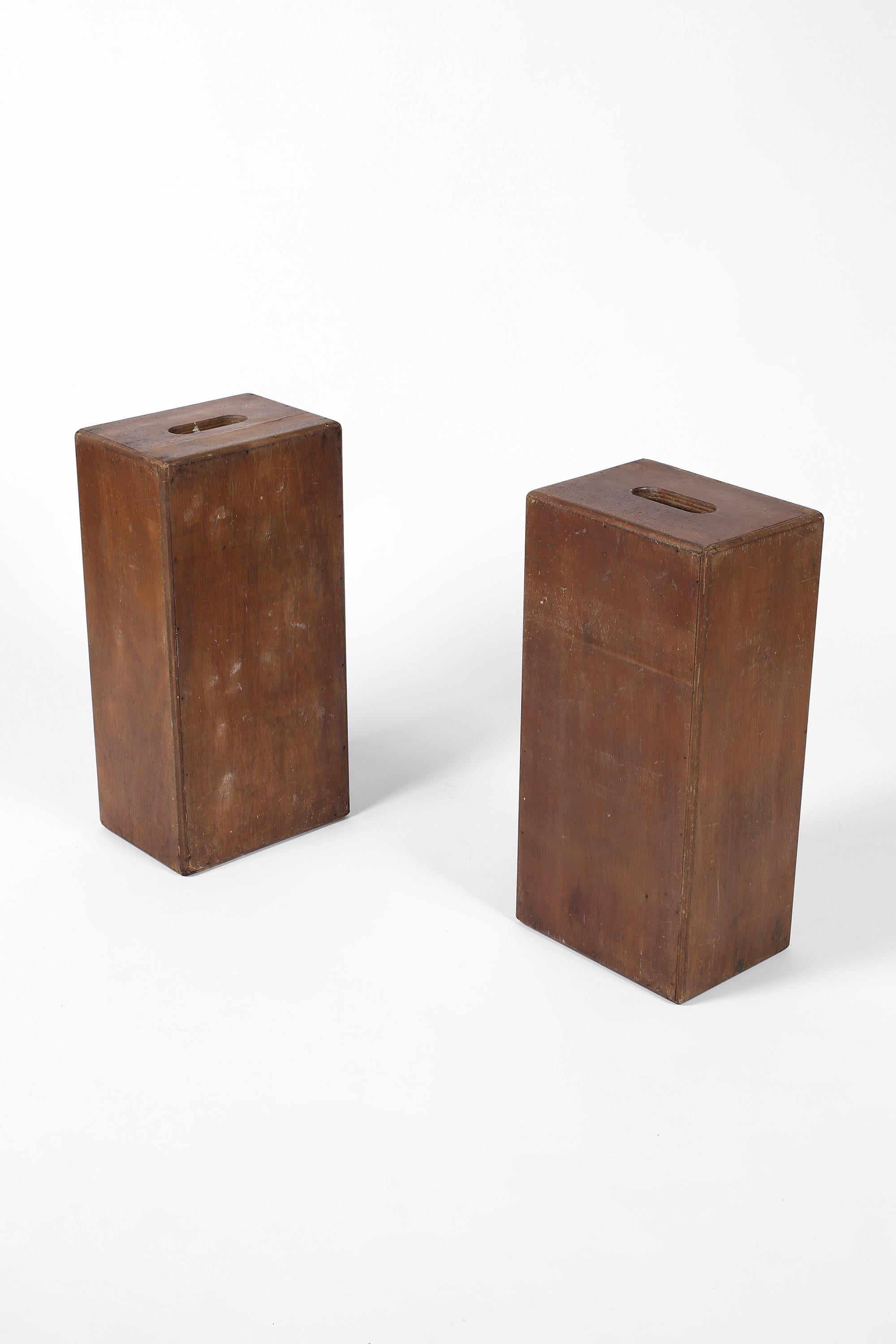 A pair of architectural box stools, simply constructed from heavily patinated ply timber, in the manner of Le Corbusier. Also suited as side/drinks tables. French, c. 1940s.