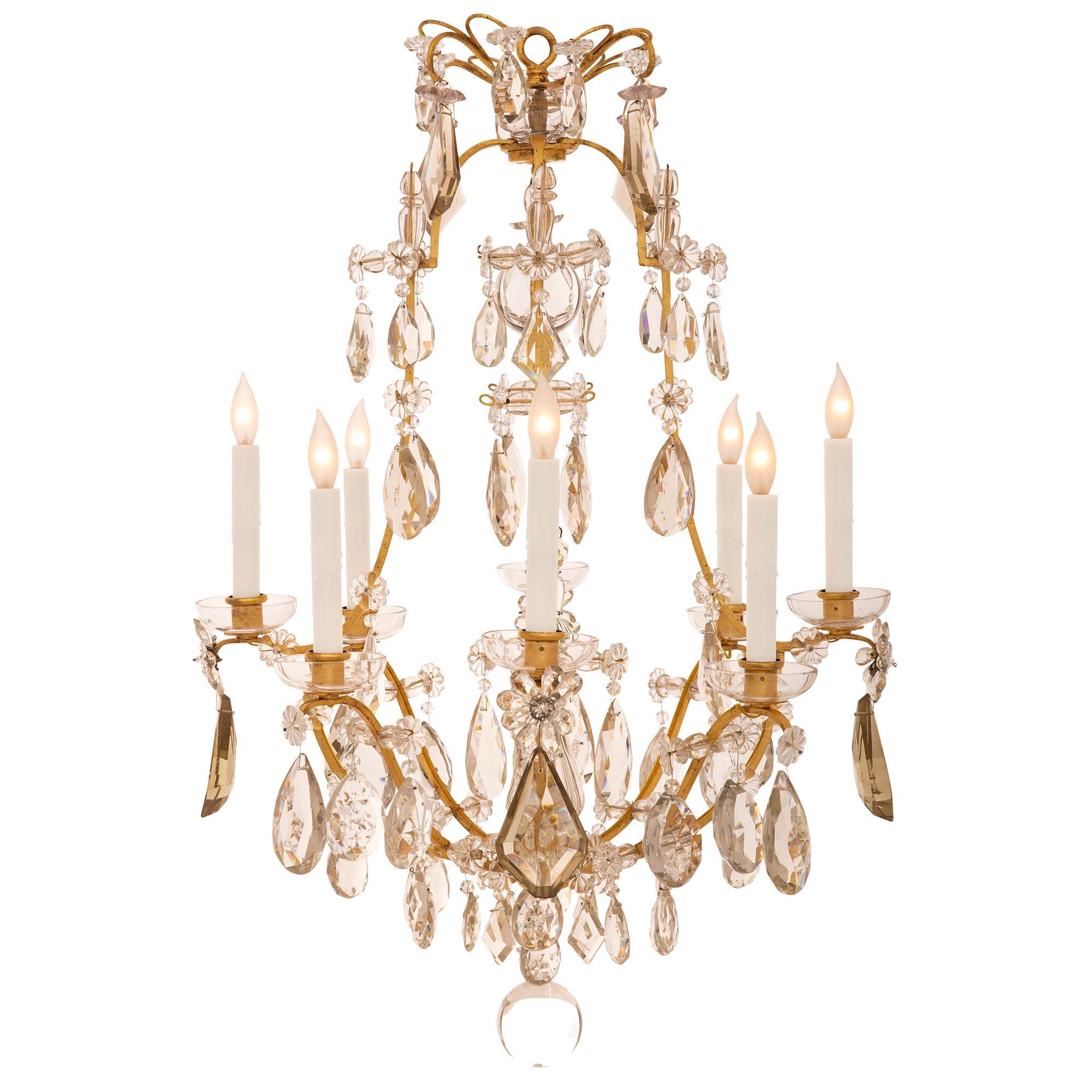 A beautiful French turn of the century Louis XV st. gilt metal and Baccarat crystal chandelier. The eight arm chandelier is centered by a solid Baccarat crystal ball pendant amidst an exceptional array of tear drop and kite shaped pendants. The