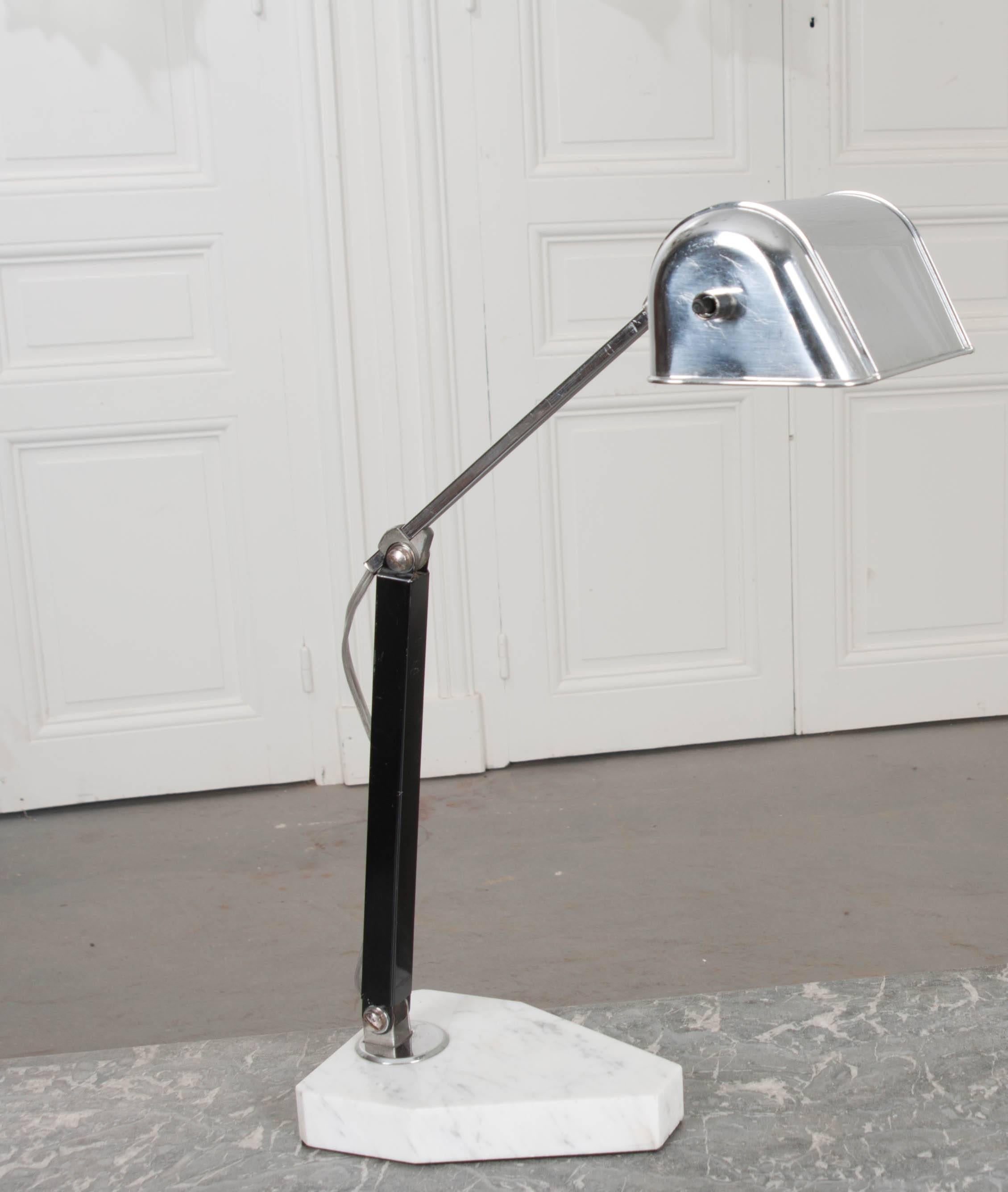 An adjustable chrome and marble desk lamp from 1940s France. The stylish light fixture features a smart, industrial design that is sophisticated and chic. The lamp can be worked into a myriad of configurations, as shown in the detailed photos,