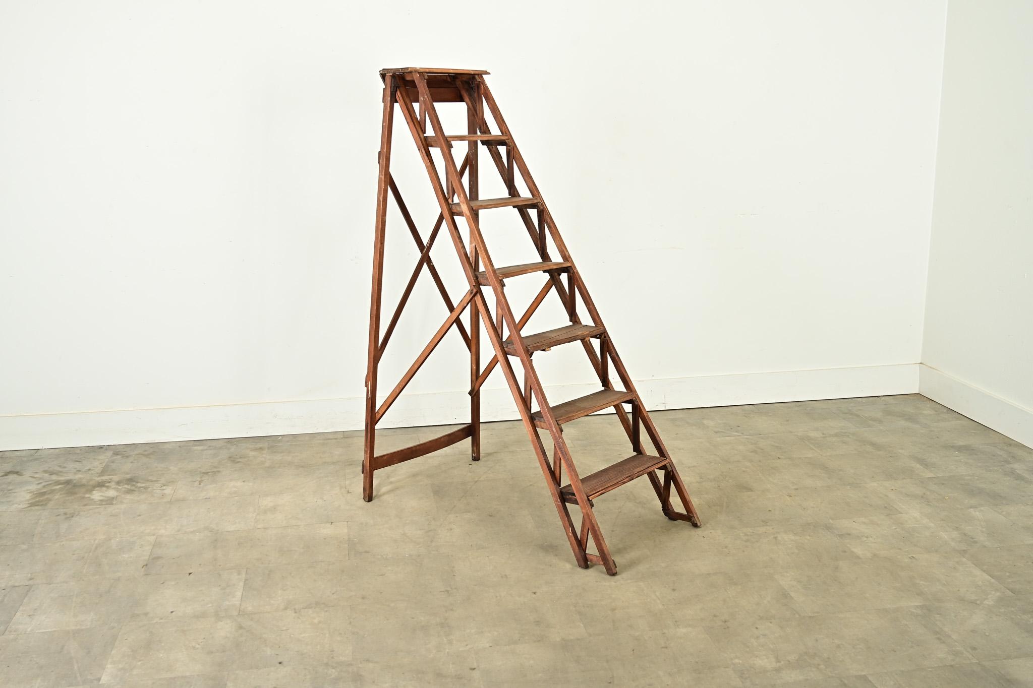 French 20th century oak folding ladder or library stairs. The design of the ladder is remarkable for all the engineering required to make it portable and stable without sacrificing the beauty in its construction. This example remains functional for