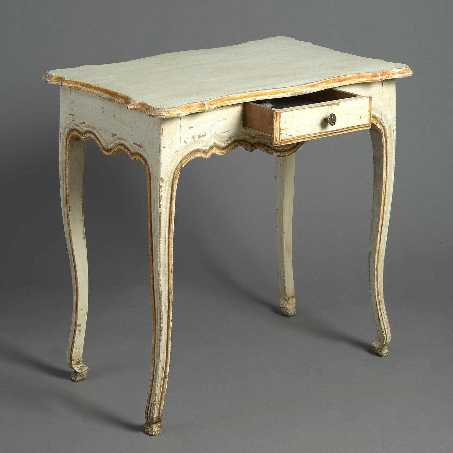 Provincial painted centre table. The serpentine top above a frieze drawer raised on cabriole legs.
Distressed paintwork.