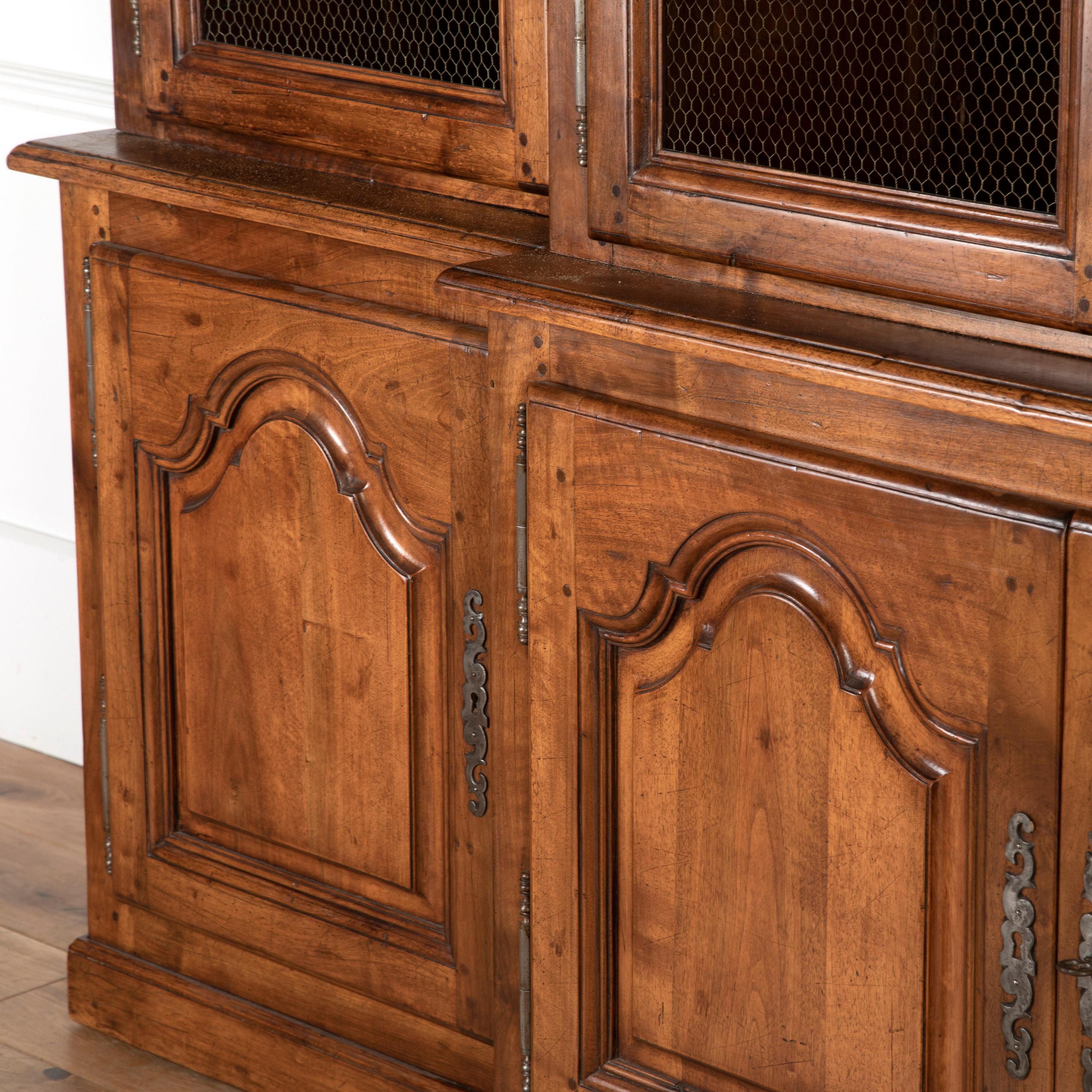 French breakfront Bibliotheque with wire to the upper doors.

Featuring traditional lift-off hinges and decorative escutcheons. All of the doors open with ease and also feature their original locks with keys. 

It has a wonderful, rich walnut