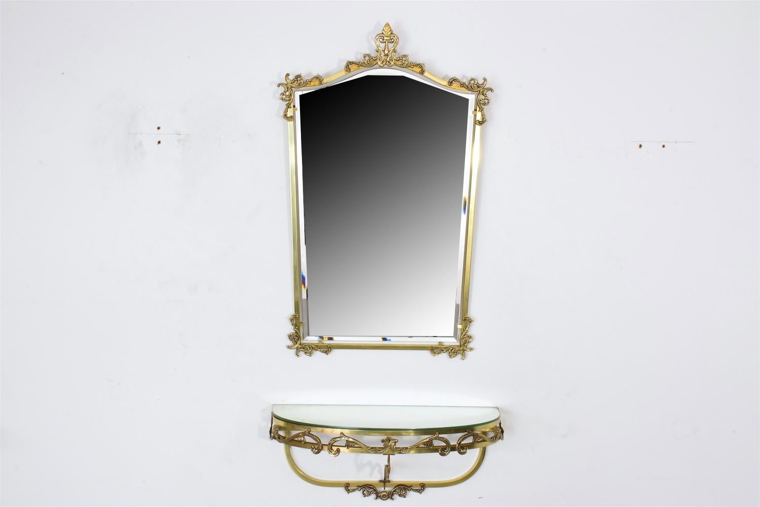 A neoclassical style polished solid brass mirror and floating console set with its beautiful original beveled rectangular mirror, chiseled S-scrolls and leaf ornaments. 
Restored condition. 
France, circa 1960s-1970s. 

MIRROR
84 cm x 53 cm x 4 cm