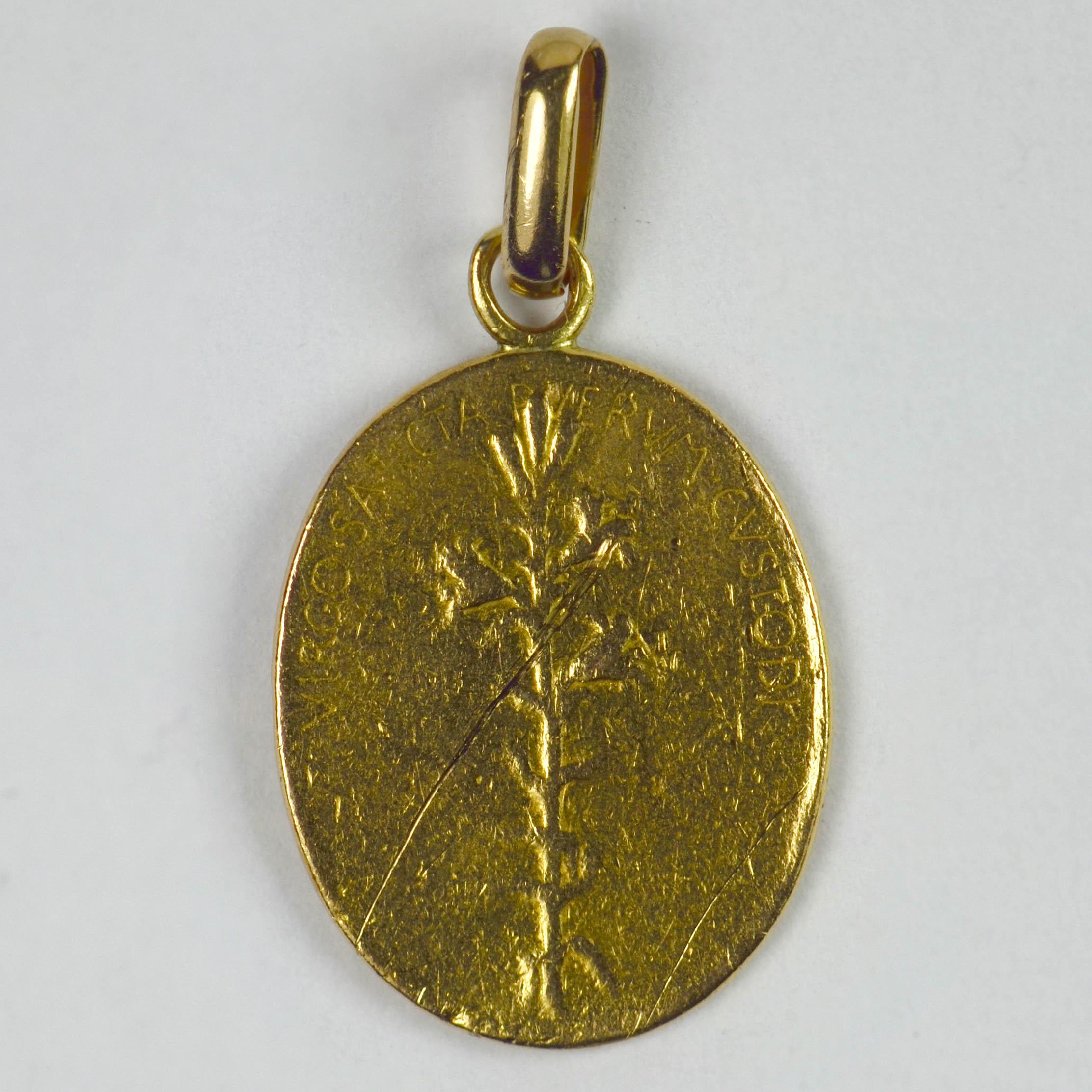 A French 22 karat (22K) yellow gold charm pendant designed as an oval disc with a carved relief of the Madonna and Child, signed O. Roty. The reverse depicting a branch of lilies with the Latin motto 'VIRGO SANCTA PUERUM CUSTODI' (Holy Virgin