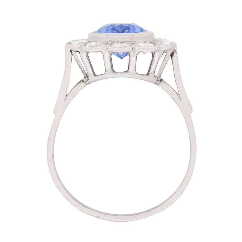 An enchanting oval-shaped sapphire, weighing 3.00 carats, is rubover set and wrapped within a glittering diamond border at the centre of this sensational ring.

The ring’s 1.20 carat diamond border is comprised of round brilliant cut diamonds, which