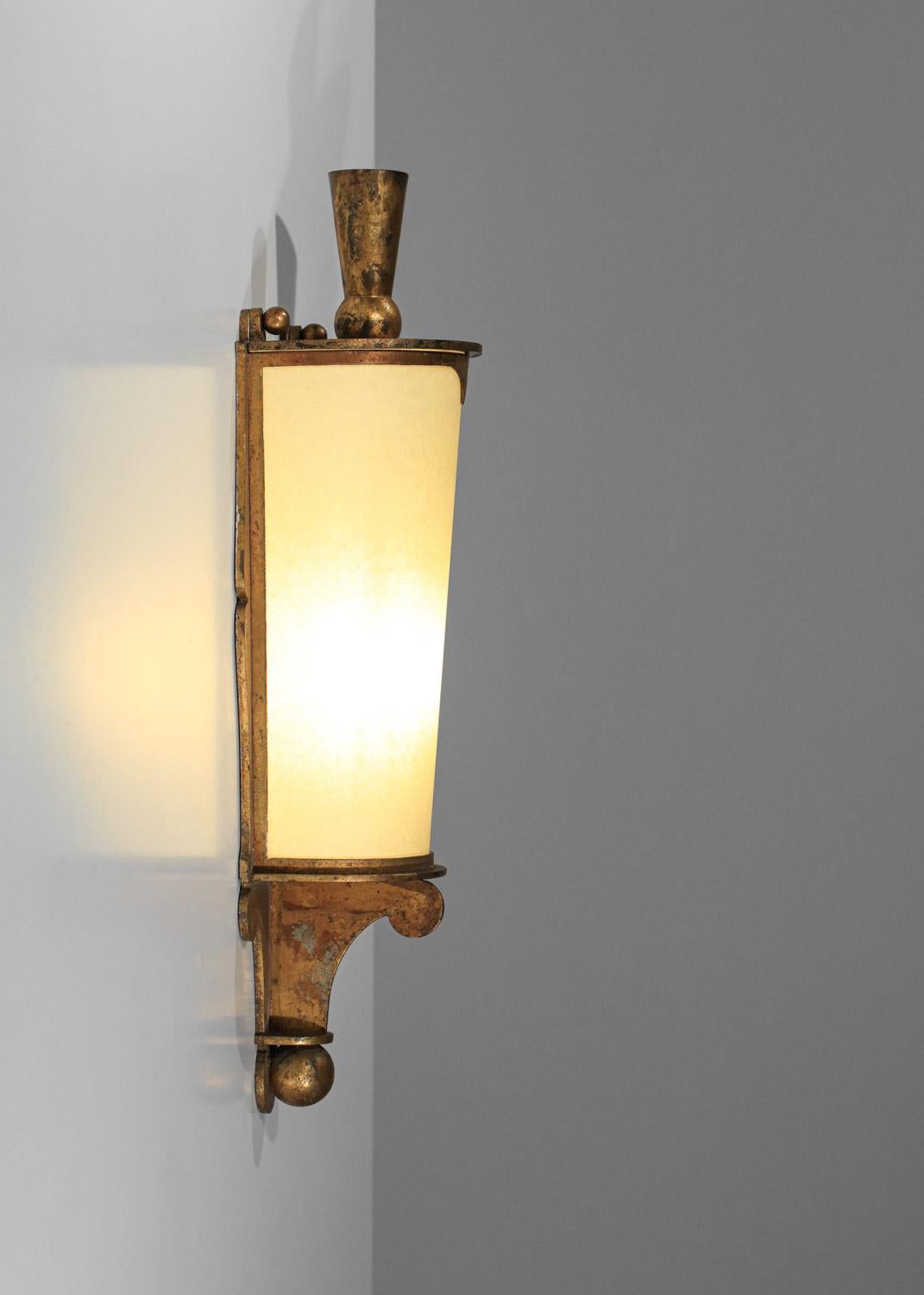 Large French wall sconce from the 40s. Sconce structure in gilded metal, shade in beige opaque paper (refurbished and custom-made). Very nice design for this decorative sconce that diffuses a soft light. Beautiful vintage condition, with traces of