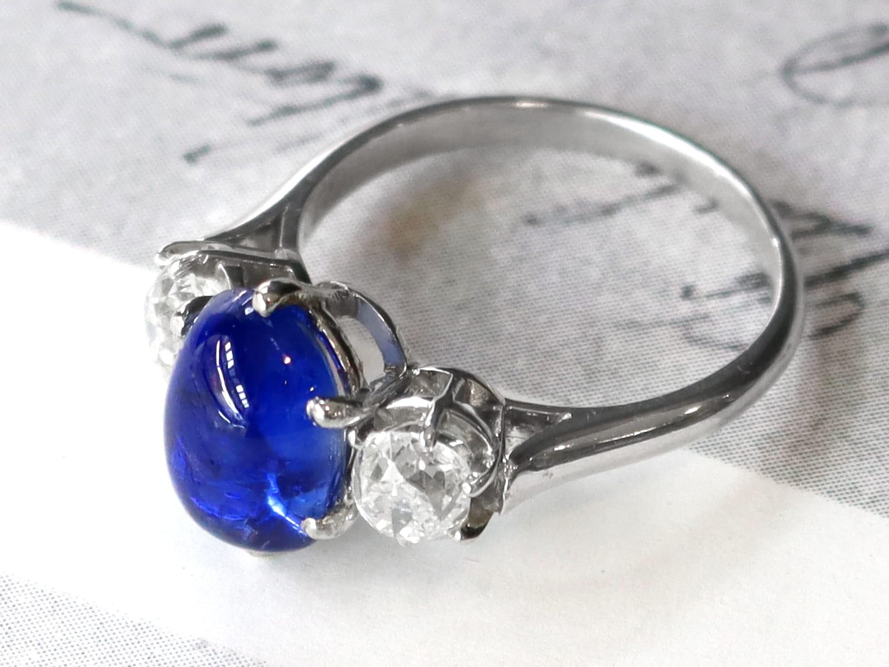 A stunning antique 4.90 carat Burmese sapphire and 1.39 carat diamond, platinum cocktail ring; part of our diverse antique jewelry and estate jewelry collections.

This stunning, fine and impressive antique cabochon cut sapphire ring has been