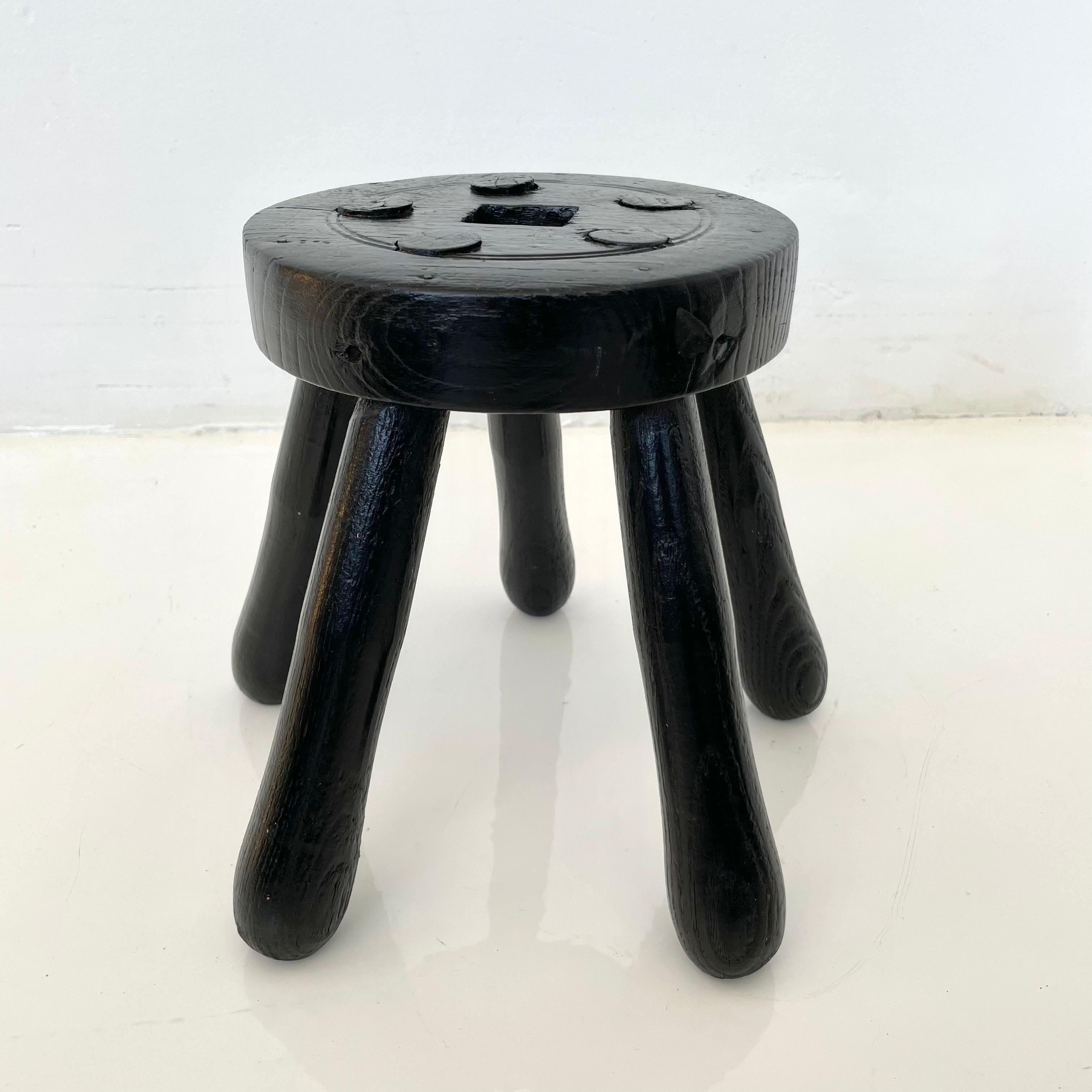 Stubby wooden stool, made in France, circa 1950s. Thick seat with five rounded legs. No nails or hardware. Great lines and shape. Petite stool with great presence. Great vintage condition. Perfect for books or objects. 
  