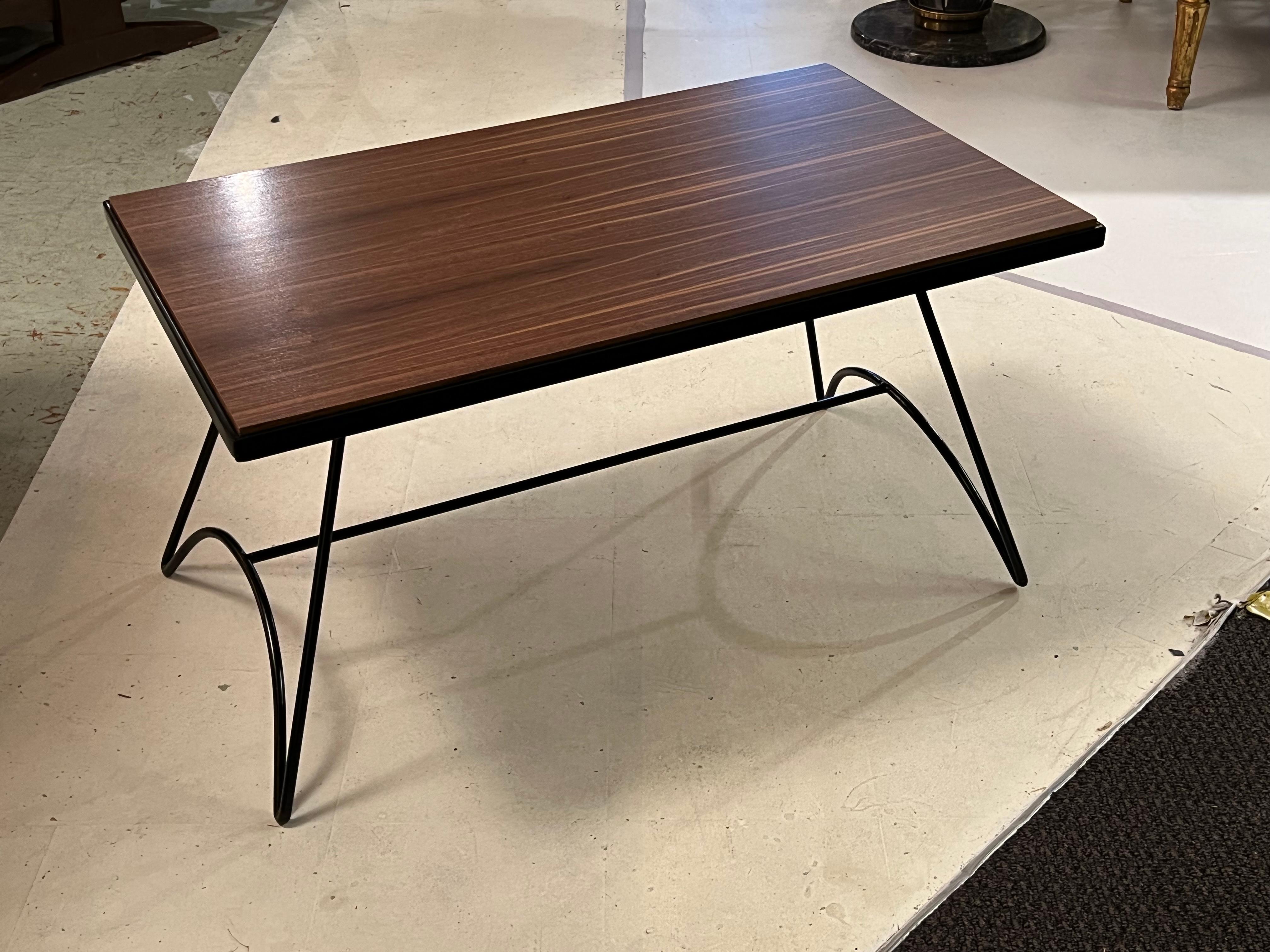 Walnut top coffee table with metal legs by Jacques Hitier.
Jacques Hitier (28 March 1917 – 5 March 1999) was a French interior architect and designer “one of the most prominent figures of decorative art of the second half of the twentieth century”.