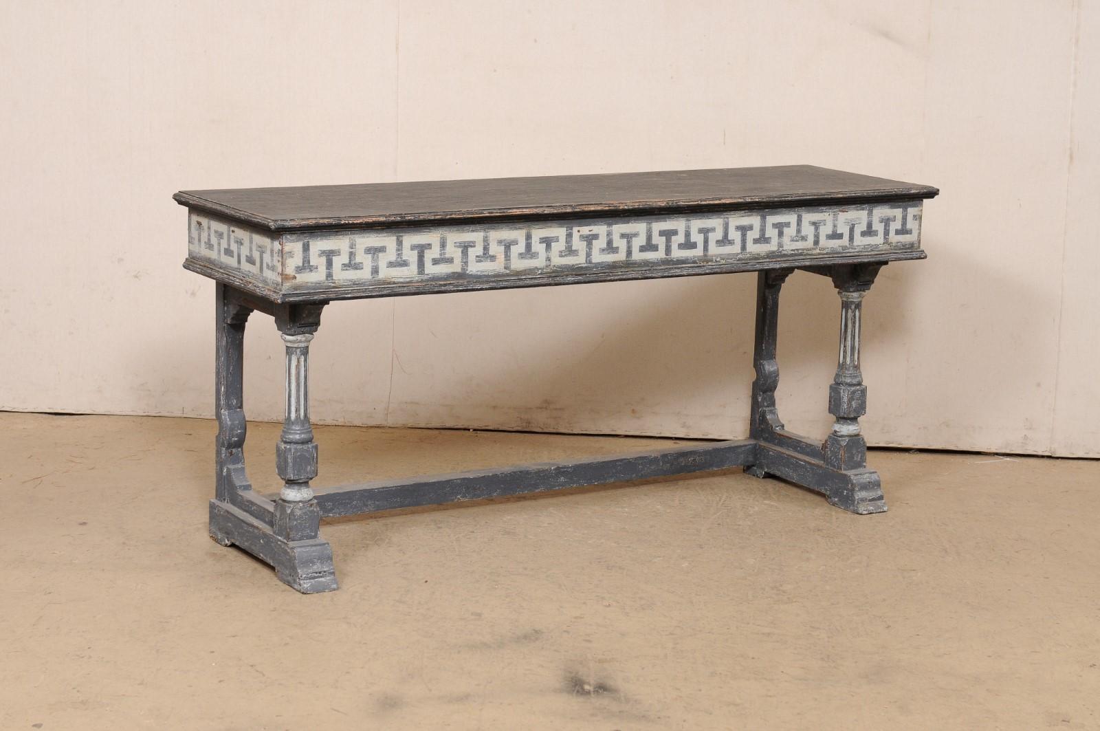 A French console table with painted Greek Key motif. This vintage table from France features a rectangular-shaped top which slightly overhangs the apron below which has been nicely decorated with a hand-painted Greek Key motif across its front and