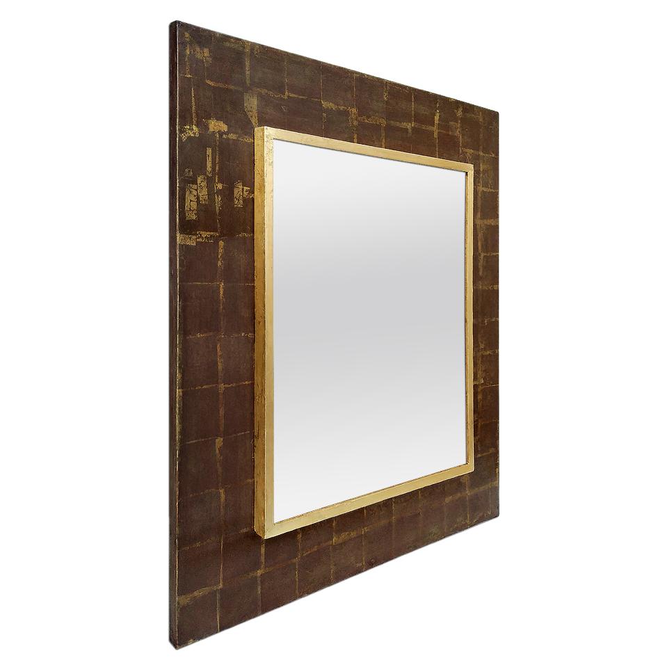 French 1970s wall mirror. Antique frame in gilded wood with a large frame with squared patterns used gilded to the patinated leaf on a background in dark brown tones. Modern glass mirror. Antique wood back.
